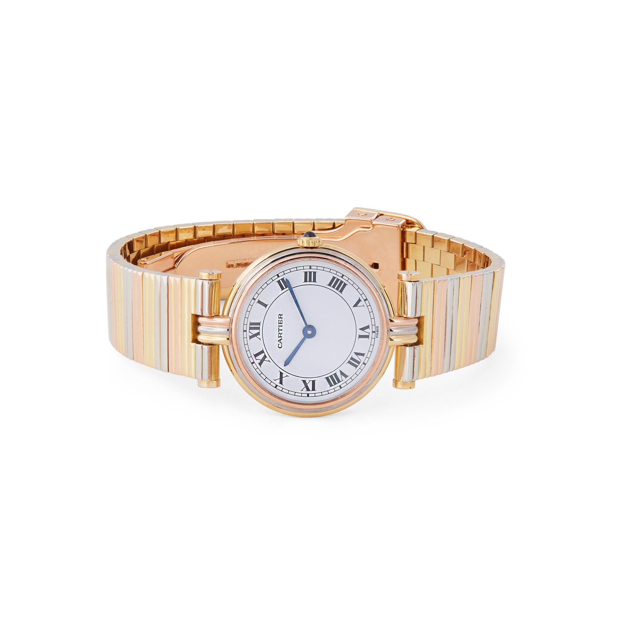 Authentic Vendome Trinity de Cartier watch crafted in 18 karat yellow, pink, and white gold, with matching bracelet. The round case diameter measures 24.5 mm and features a white dial with black Roman markers and blued-steel hands. The most distinct