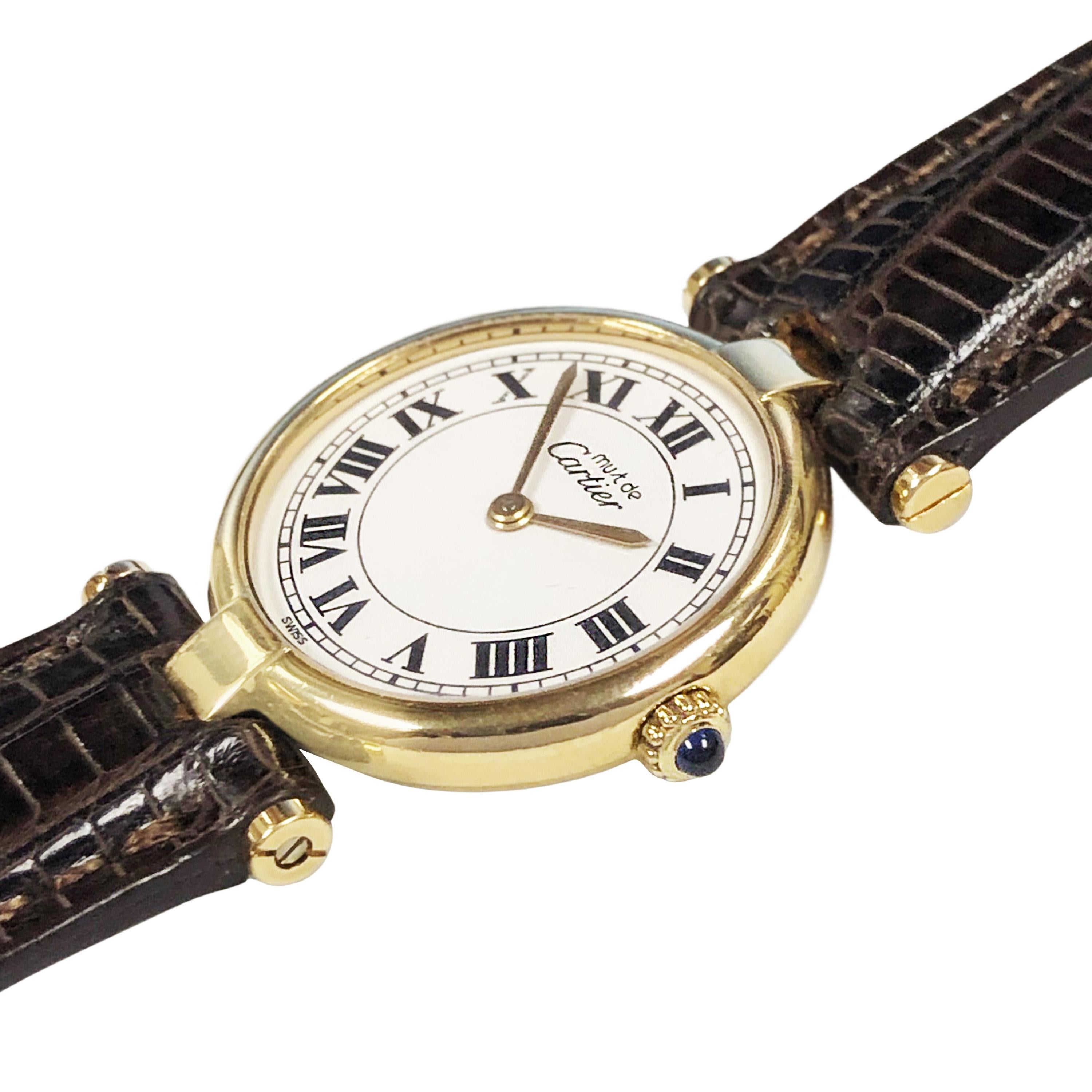 Circa 2005 Cartier Must De Cartier Vendome Ladies Wrist Watch, 24 MM 2 Piece Vermeil, Gold Plate on Sterling Silver case. Quartz Movement, White dial with Black Roman Numerals. New Brown Lizard strap and a Cartier Gold Plate Tang Buckle. Comes in a