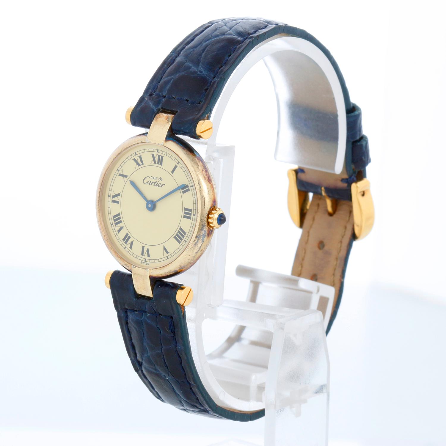 Cartier Vendome Vermeil Ladies Watch - Quartz. Vermeil ( 24 mm). Champagne dial with roman numerals. Blue Cartier strap with Cartier tang buckle. Pre-owned with custom box and Cartier papers.