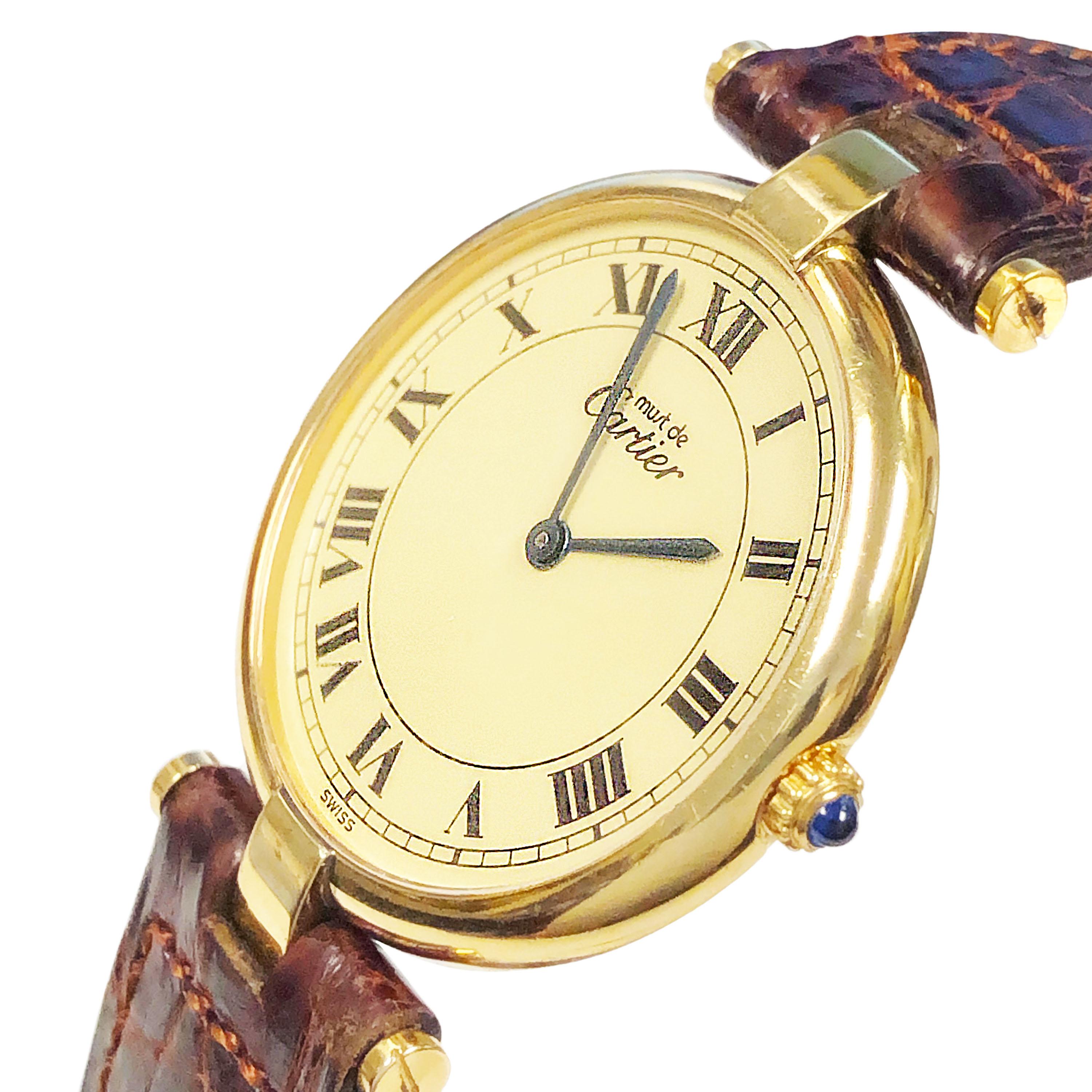 Circa 1988 Cartier Vendome collection Wrist Watch, 30 MM Vermeil, Gold Plate on Sterling Silver case. Quartz Movement, Cream dial with Black Roman numerals. Sapphire Crown. Original Cartier brown Croco strap with Cartier Gold Plated Tang buckle.