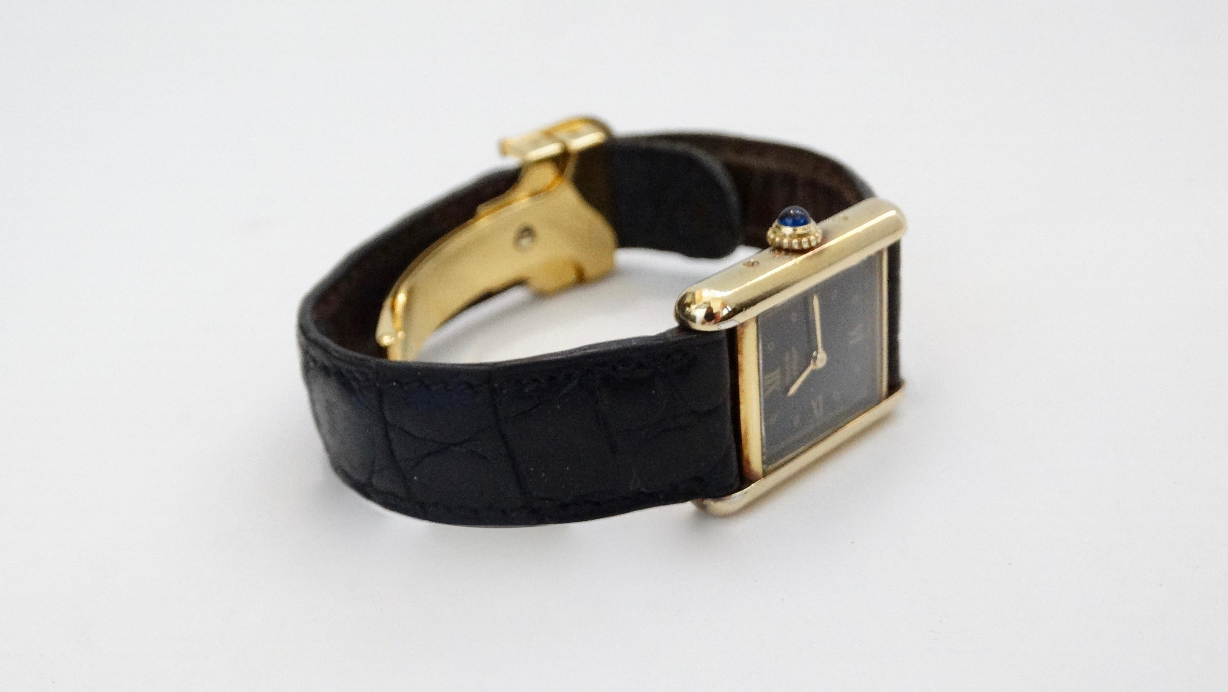 Gorgeous Cartier Vermeil Alligator 20mm Must de Cartier Tank watch. A classic Swiss made timepiece with a black alligator leather strap and a sterling silver 18k yellow gold plated vermeil bezel and buckle. Features Quartz movement and a synthetic