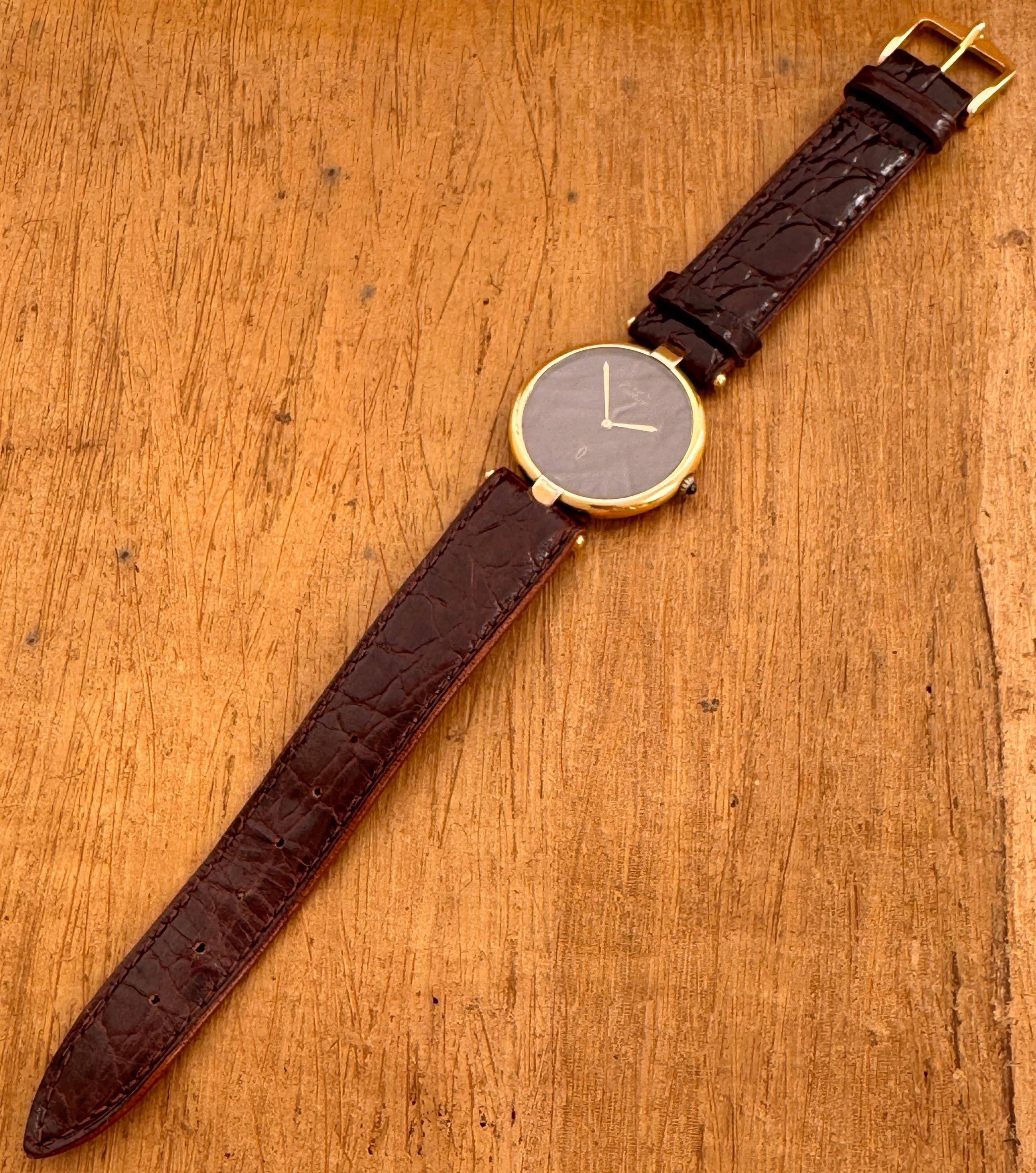   Description
Brand: Cartier

Model: Vermeil Must

Reference Number: 17 082201

Country Of Manufacture: Switzerland

Movement: Quartz

Case Material: Gold Plated Silver

Measurements : Case width: 30mm. (without crown)

Band Type :After Market Calf