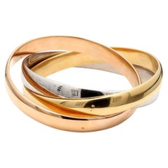 Cartier Vintage 102.40 Grams Size 7.5 Inch 18 Karat Gold Bangle Trinity Bracelet