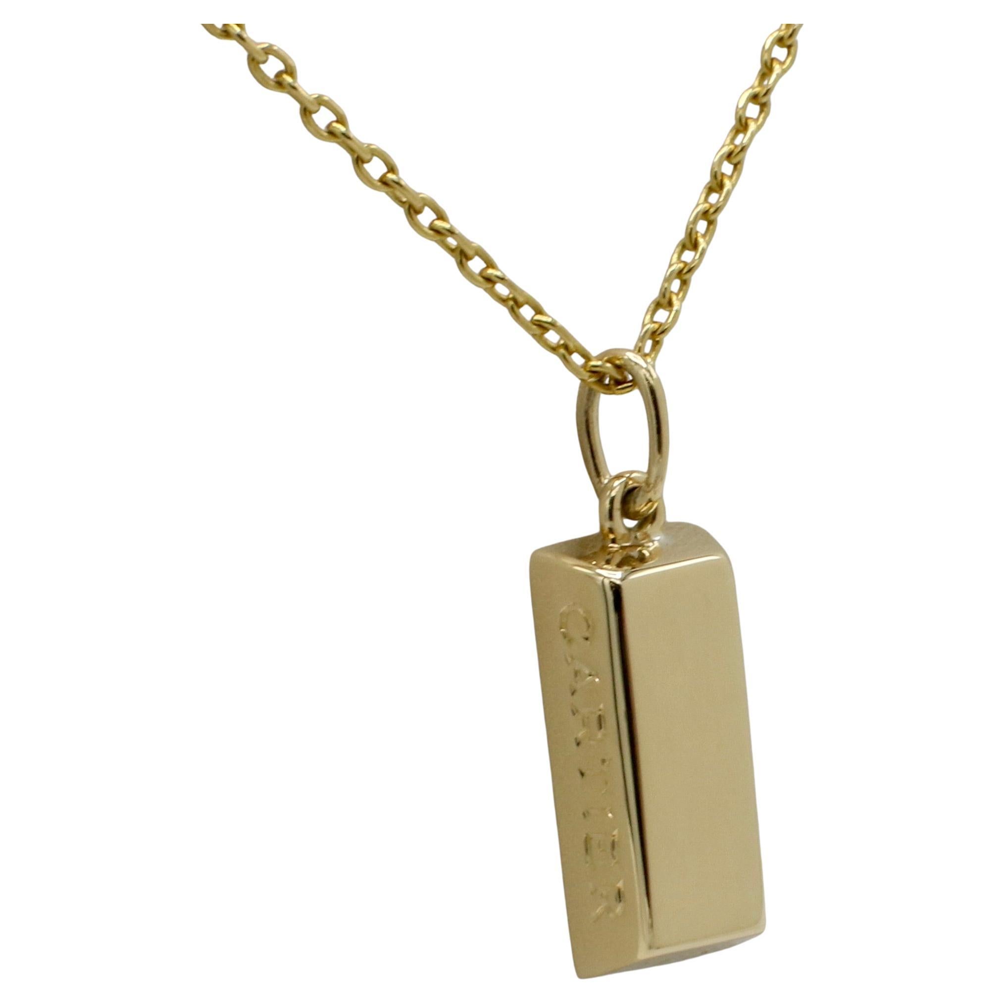 Cartier Vintage 1/4 Quarter Ounce Gold Bar Pendant Charm Drop Necklace 
Metal: 18k yellow gold
Weight: 12.78 grams
Chain: 20 inches (Cartier)
Pendant: 9 x 18mm
Signed: ©Cartier 18K 
SKU TOD F35000267