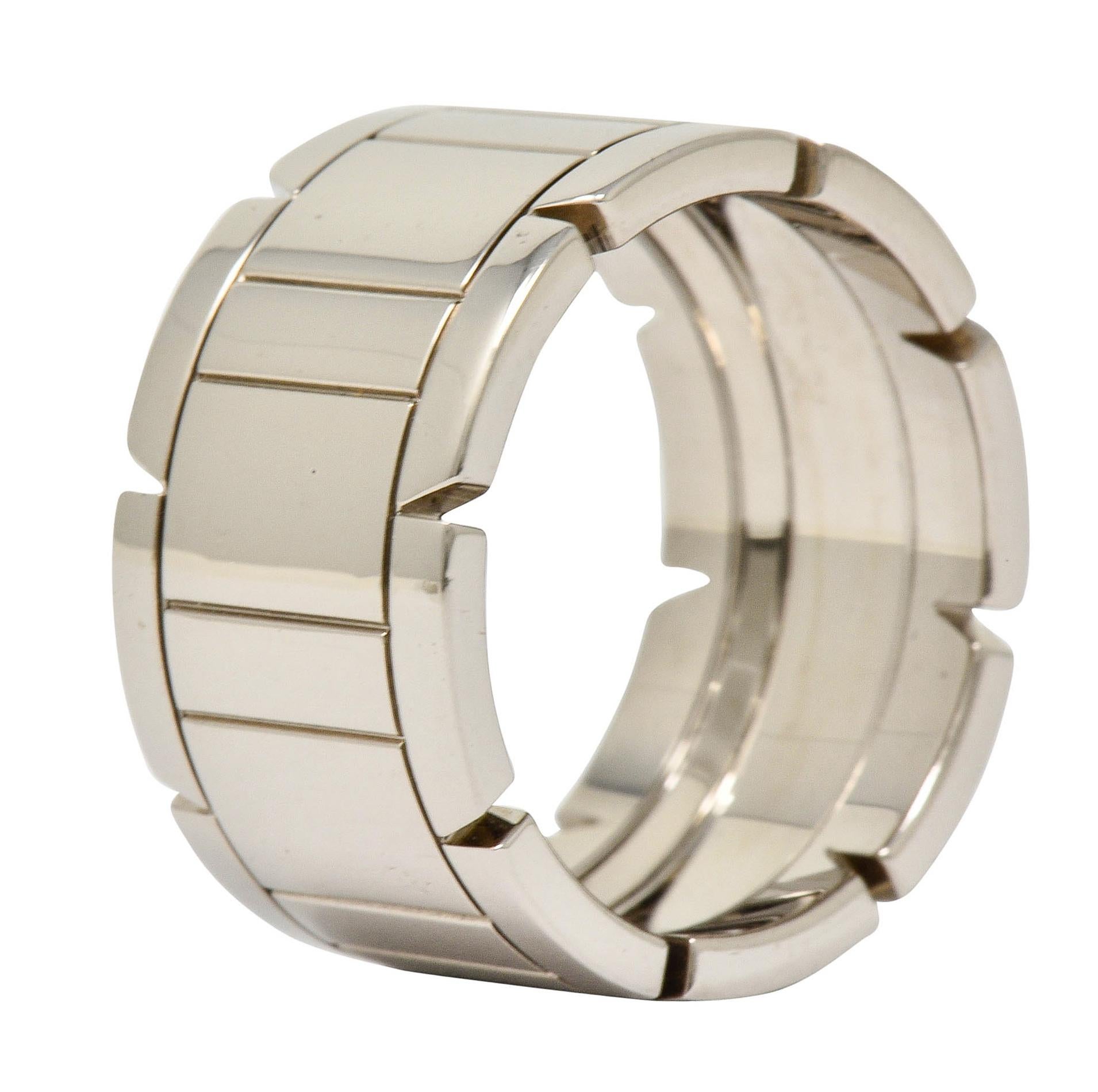 Wide band ring features a deeply engraved center depicting wide and narrow rectangles

Flanked by polished white gold edges with a pierced triangular motif

Numbered and fully signed Cartier with French maker's mark

Stamped 750 for 18 karat