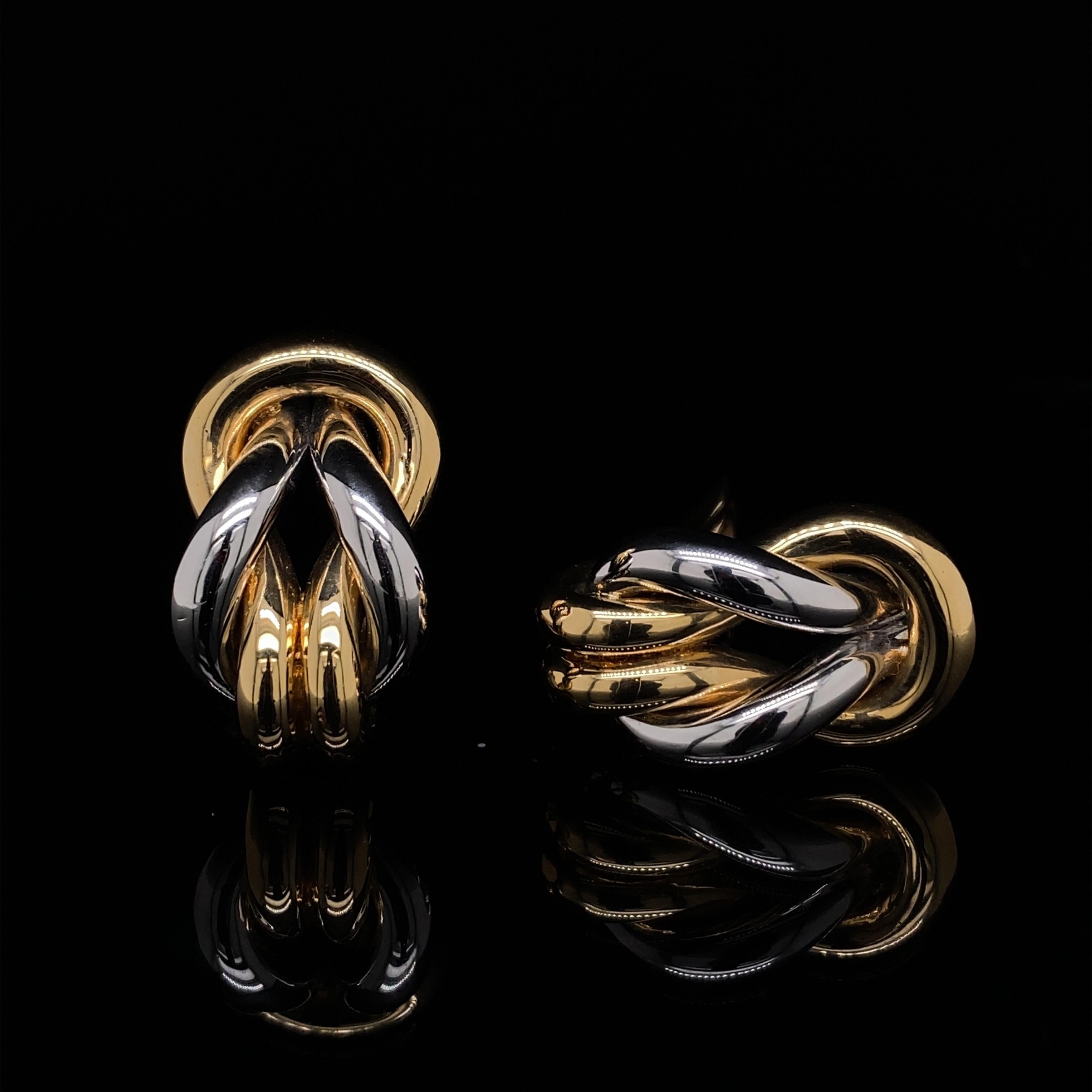 Cartier vintage 18 karat yellow and white gold clip earrings.

A unique pair of vintage Cartier bi-metal 18 karat gold earrings.

Crafted in polished gold, featuring a striking design of two elegant interlocking knots.

Signed on the clip fittings