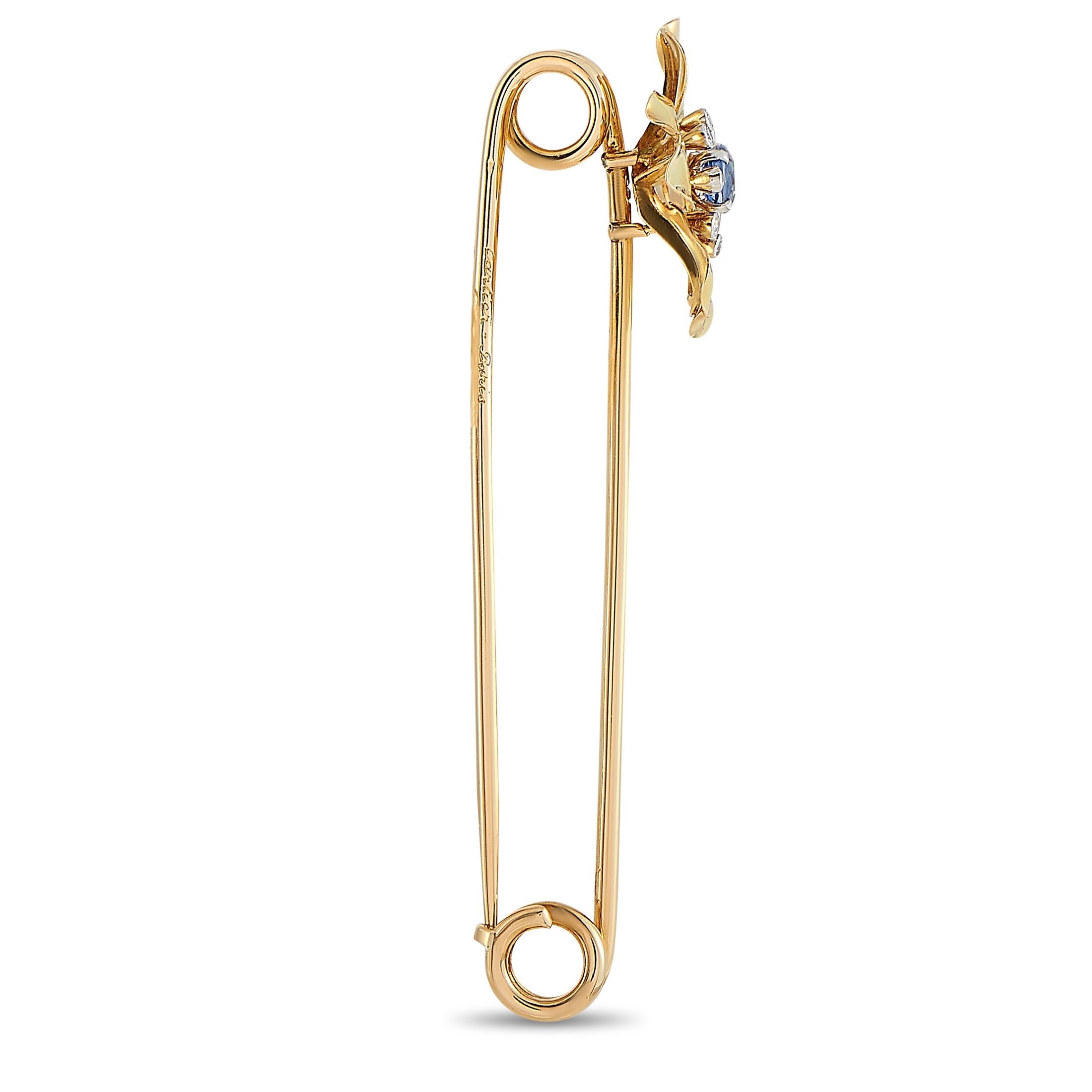 This vintage Cartier safety pin is made of 18K yellow gold and boasts a flower motif embellished with diamonds and a sapphire. The pin weighs 10.3 grams and measures 2.88” in length and 1” in width.
 
 Offered in estate condition, this item includes