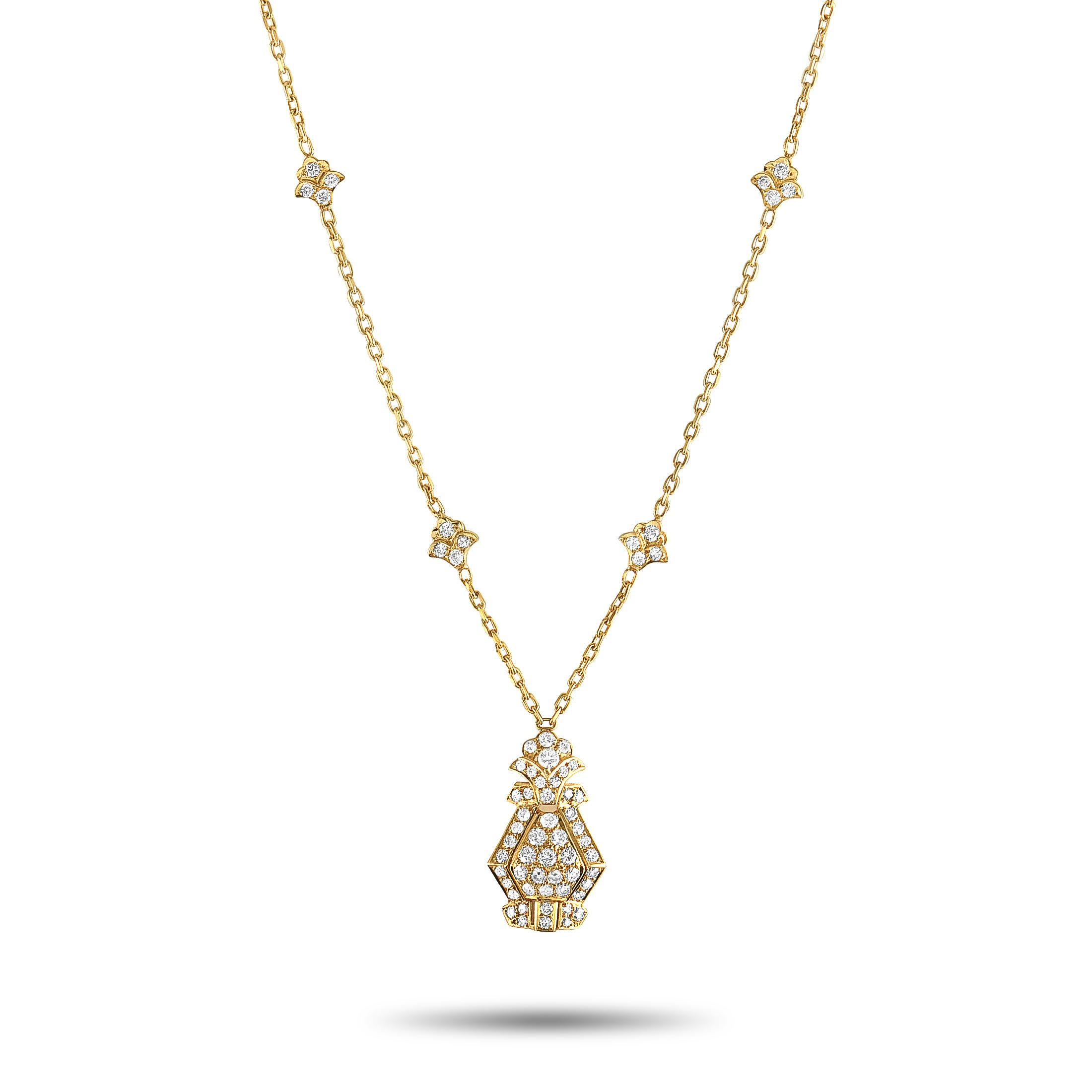 This vintage Cartier necklace is crafted from 18K yellow gold, featuring a 16” chain with spring ring closure and a pendant that measures 1” in length and 0.60” in width. The necklace weighs 11.6 grams and is embellished with a total of 1.40 carats