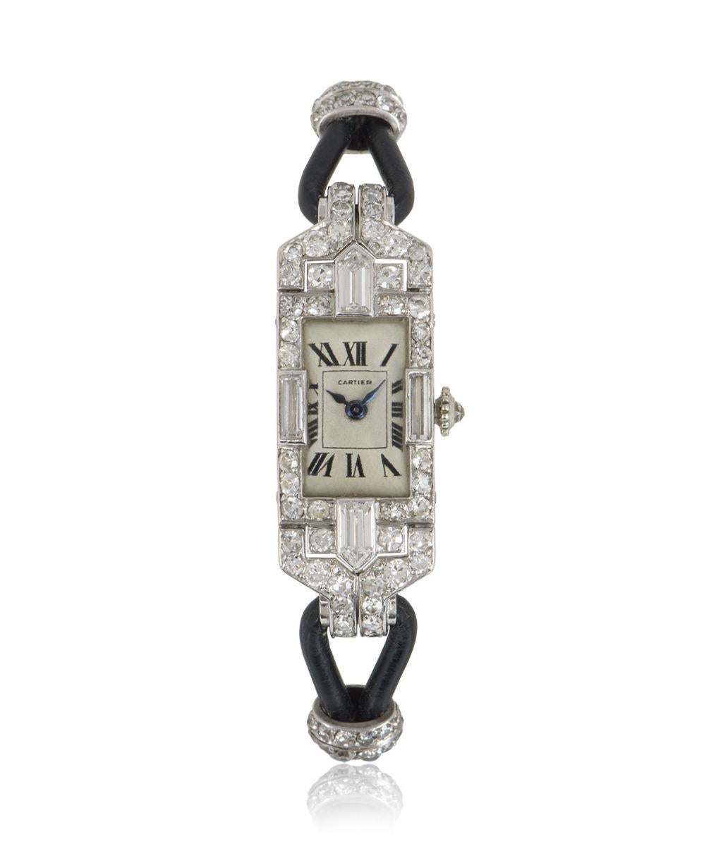 A 14 mm rare women's vintage cocktail Art Deco dress watch by Cartier, in platinum, featuring a cream dial with Roman numerals and blued steel hands, concealed with plastic glass. The bezel, case and lugs are adorned with diamonds in both round