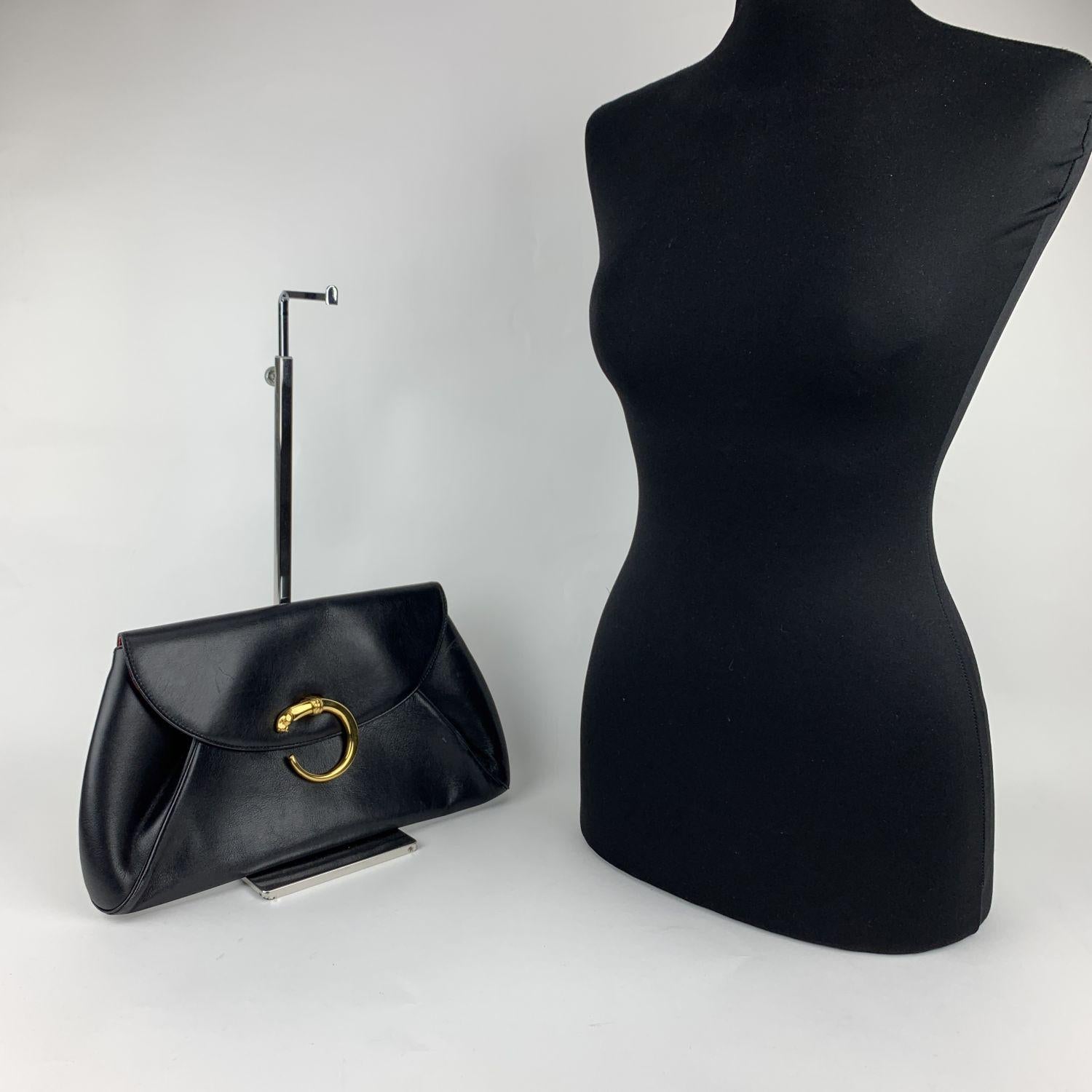 Vintage CARTIER black leather clutch bag. Made of good quality and thick leather. Gold tone Panthere opening with flap. Gold-tone Panthere metal has 'A 2830 and Cartier 1990' engraving. Red Leather lining. 1 side zip pocket and 1 D-ring.