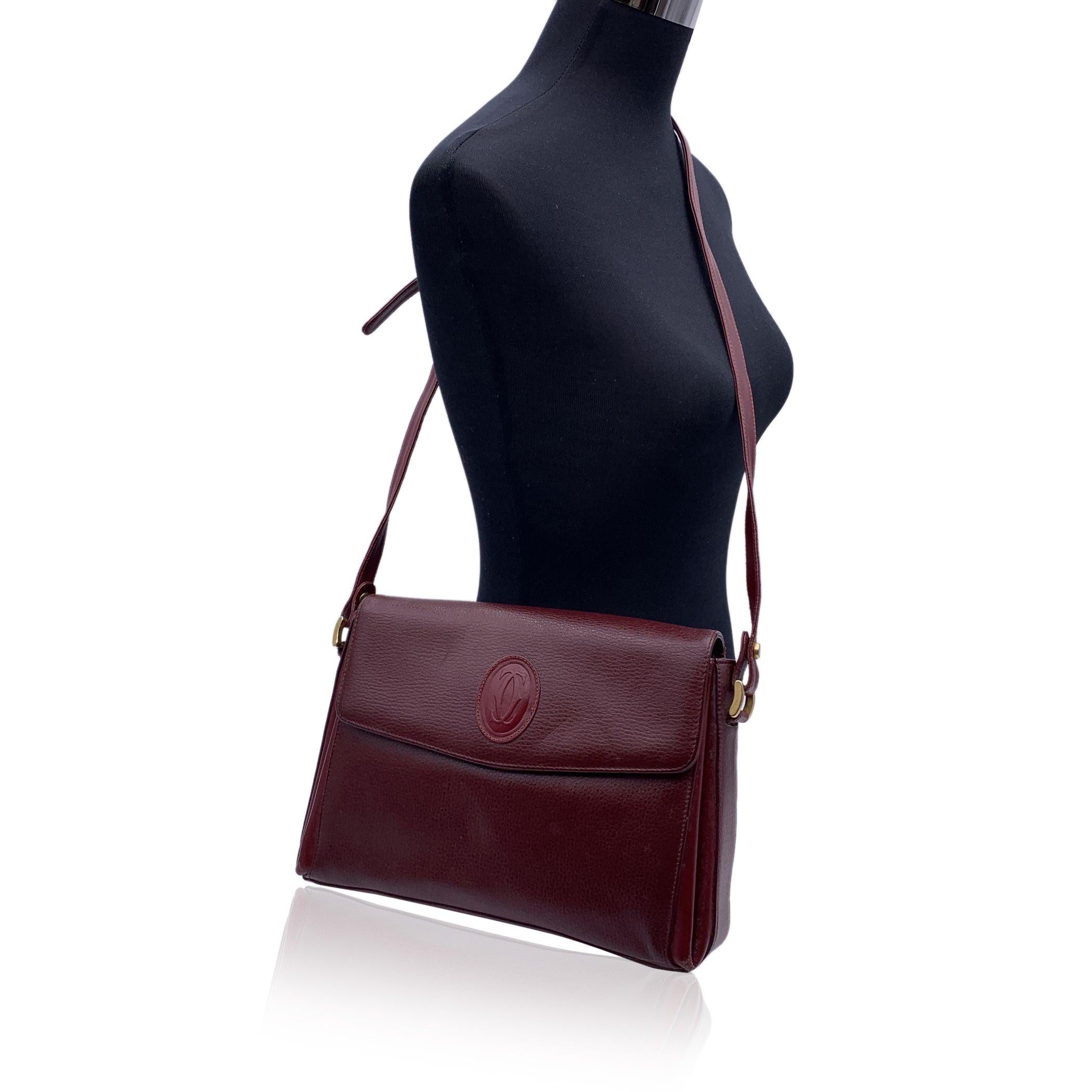 This beautiful Bag will come with a certificate of authenticity provided by third party authenticators. The certificate will be provided at no further cost CARTIER Paris Vintage shoulder bag in Burgundy genuine leather. Flap with magnetic button