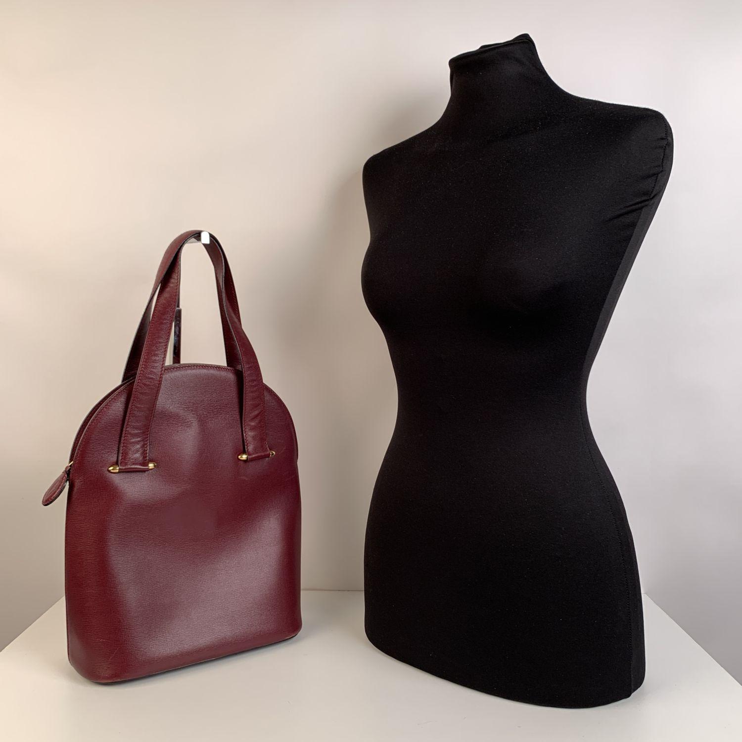 Vintage Cartier tote handbag, crafted in burgundy leather. Upper zipper closure. 4 bottom feet. Burgundy lining with CARTIER signature's pattern. 1 side zip pocket & 1 side open pocket inside. 'Cartier Paris' tag inside.


Details

MATERIAL: