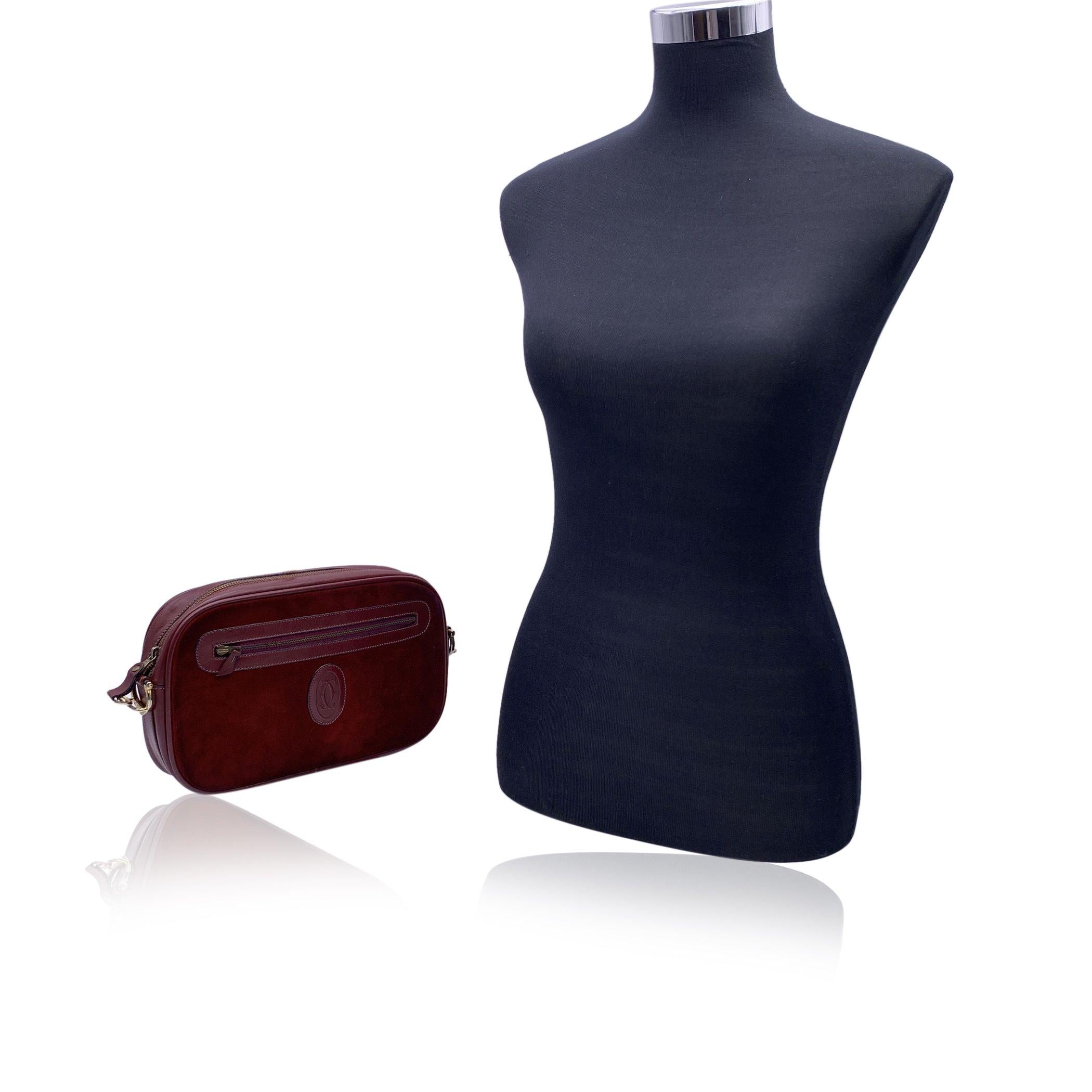 CARTIER Paris Vintage clutch bag in Burgundy suede and genuine leather. Upper zipper closure. 1 front zip pocket. Cartier logo patch on the front. Burgundy lining . 1 side zip pocket inside. 'Cartier Paris' tag inside Condition B - VERY GOOD The bag