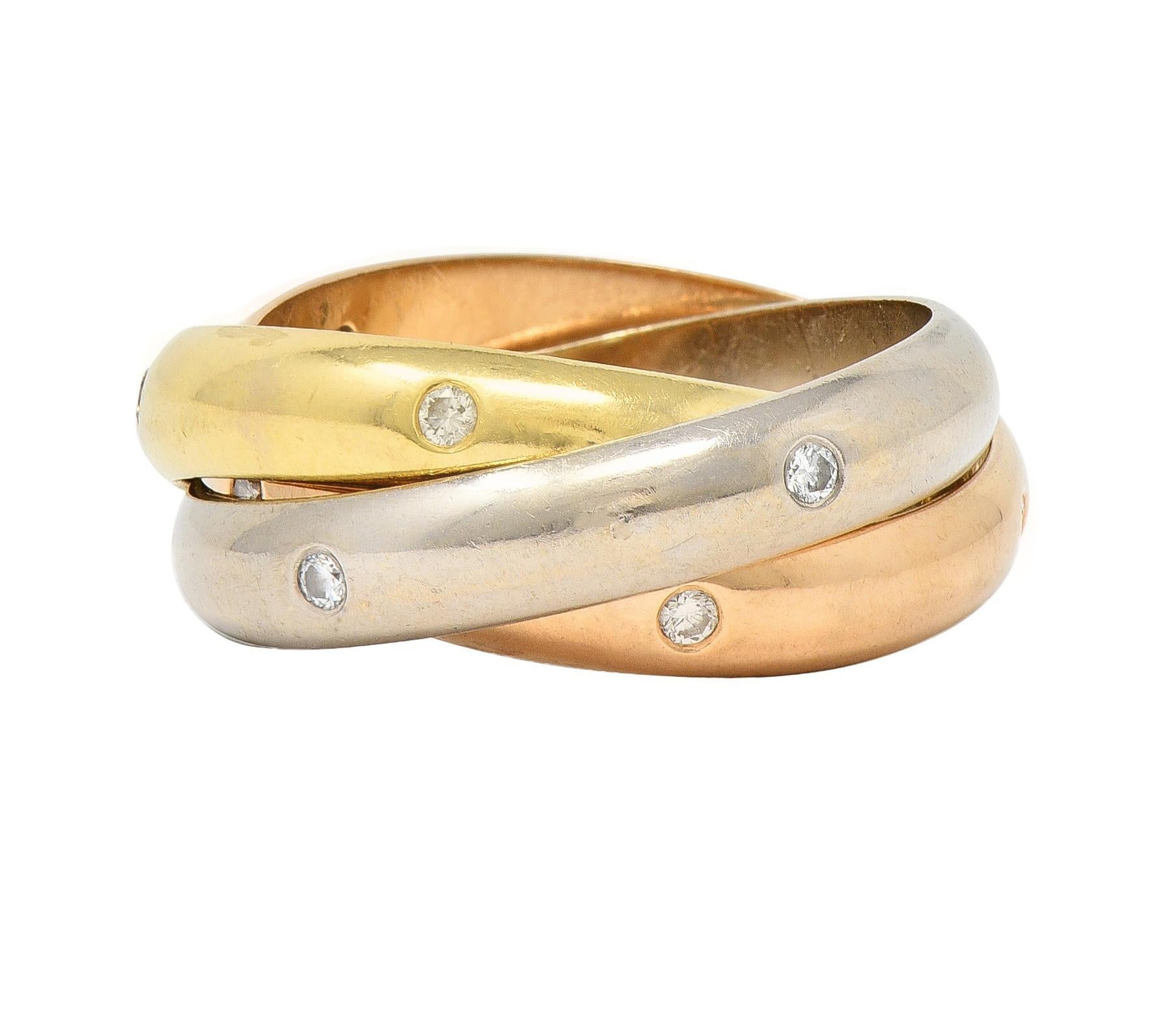 Ring is comprised of three interlocking bands of rose, white, and yellow gold
Flush set with round brilliant cut diamonds throughout 
Weighing approximately 0.38 carat total - G color with VS clarity
With high polished finish throughout
Stamped for