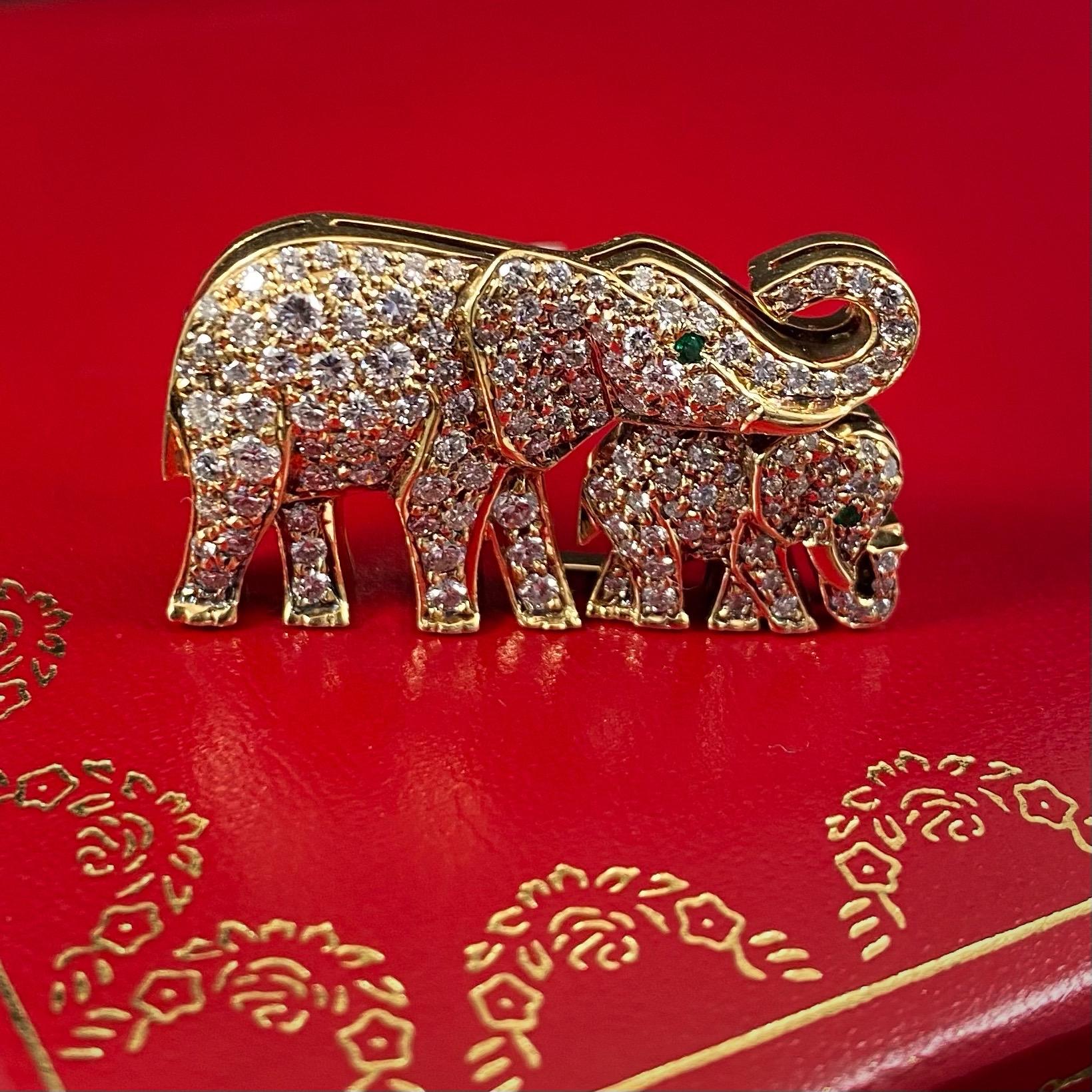 Cartier vintage diamond and emerald elephant with baby calf brooch pin in 18K yellow and white gold, French, 1990s (circa 1992), accompanied by a Cartier red pouch. This jewel is designed as a mother elephant walking with its calf, both animals