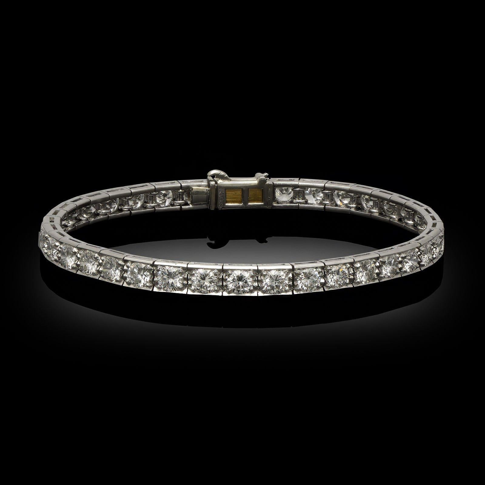 Description
A 5.50ct vintage diamond line bracelet in platinum, by Cartier, circa 1960. This classic articulated line bracelet has a line of uniformly sized round brilliant cut diamonds set in platinum and secured with a concealed tongue and box