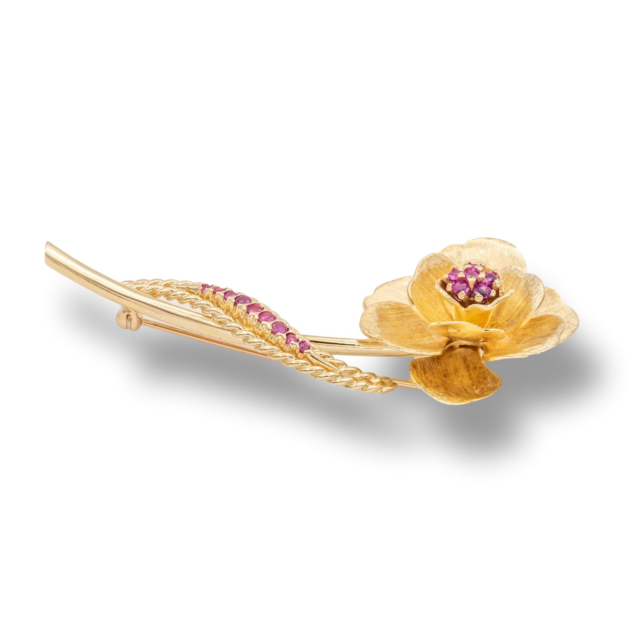 Vintage Cartier Flower brooch finely crafted in 14 karat rose gold with raspberry red rubies. This brooch has a satin finish and measures 2.75
