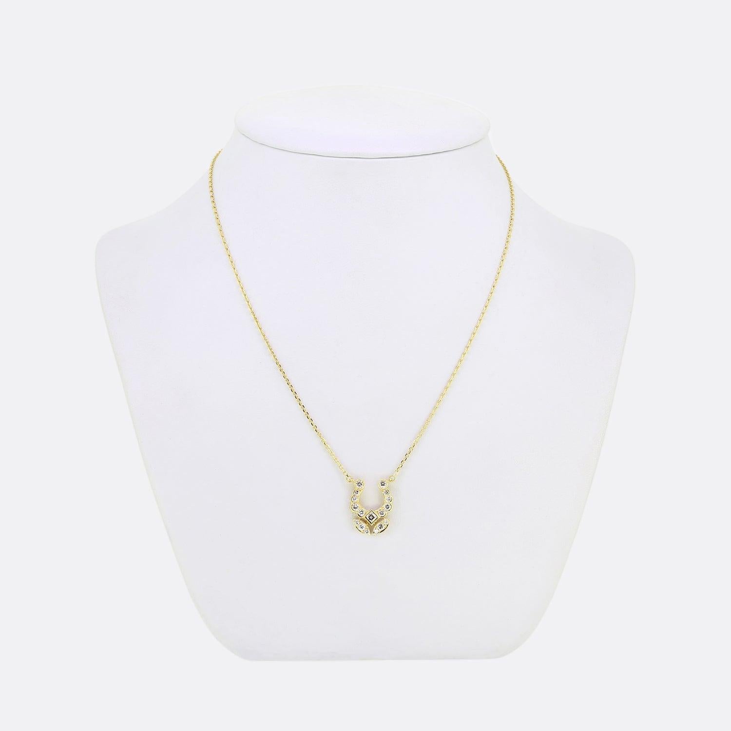 Here we have a stylish diamond necklace from the world renowned jewellery house of Cartier. This vintage piece has been crafted in 18ct yellow gold and features a horseshoe style motif. In the centre of the horse shoe there is a a lovely bright
