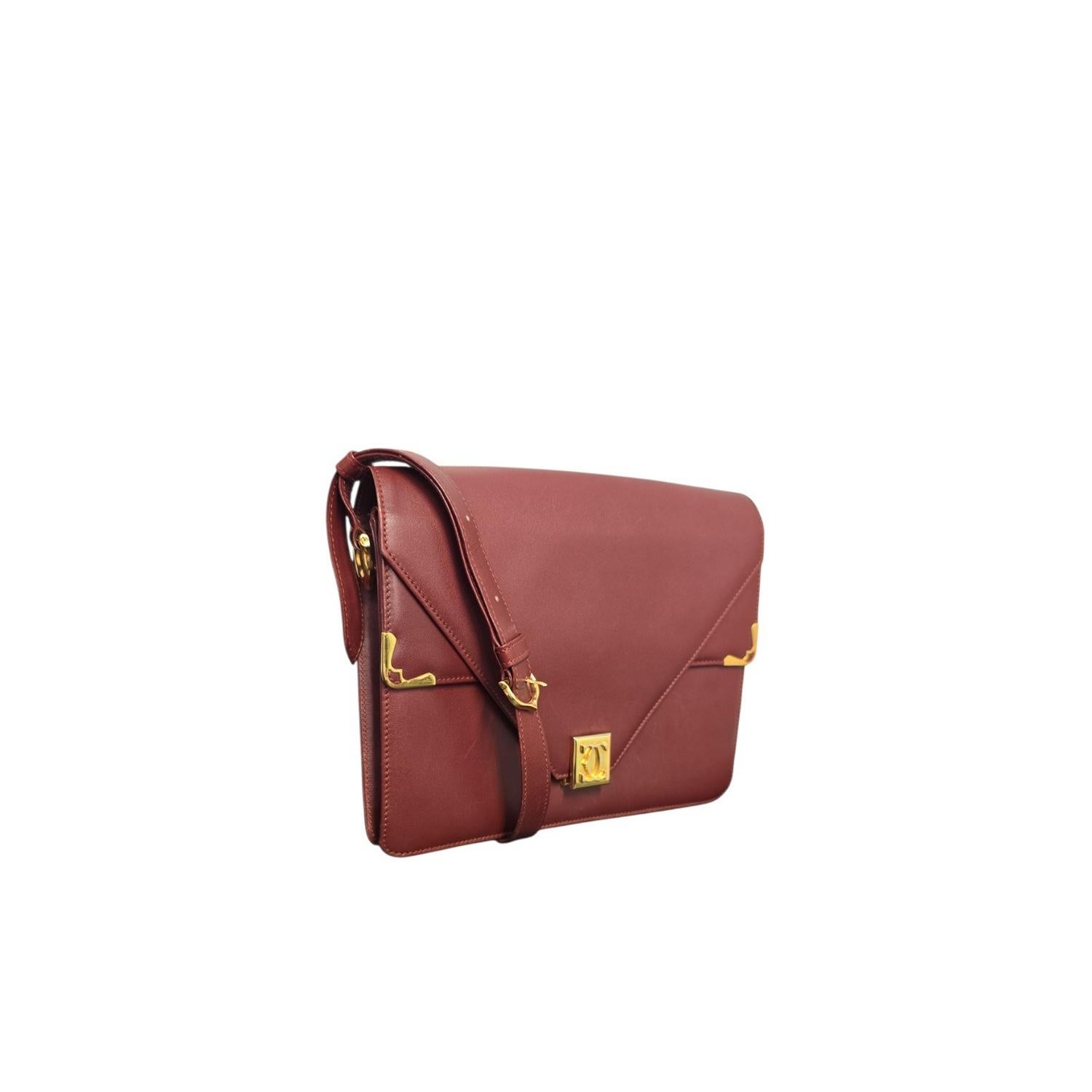 The Cartier Must de Cartier Calfskin Messenger Bag combines luxury and practicality in burgundy leather with gold accents. It features an adjustable strap, secure logo adornment flip-lock closure, and multiple pockets for organized storage. This