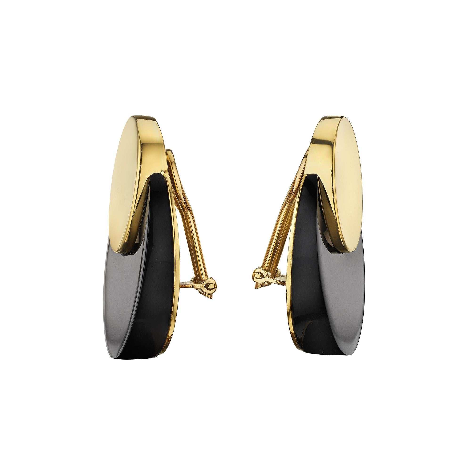 Mit ihrer zyklischen Bewegung und ihrem Sinn für Zeitlosigkeit sind diese doppelkreisigen Clip-Ohrringe aus Cartier Vintage Onyx und 18 Karat Gelbgold die Definition von modernem Chic.  Signiert Cartier.  CIRCA  1975-80.  1 3/8