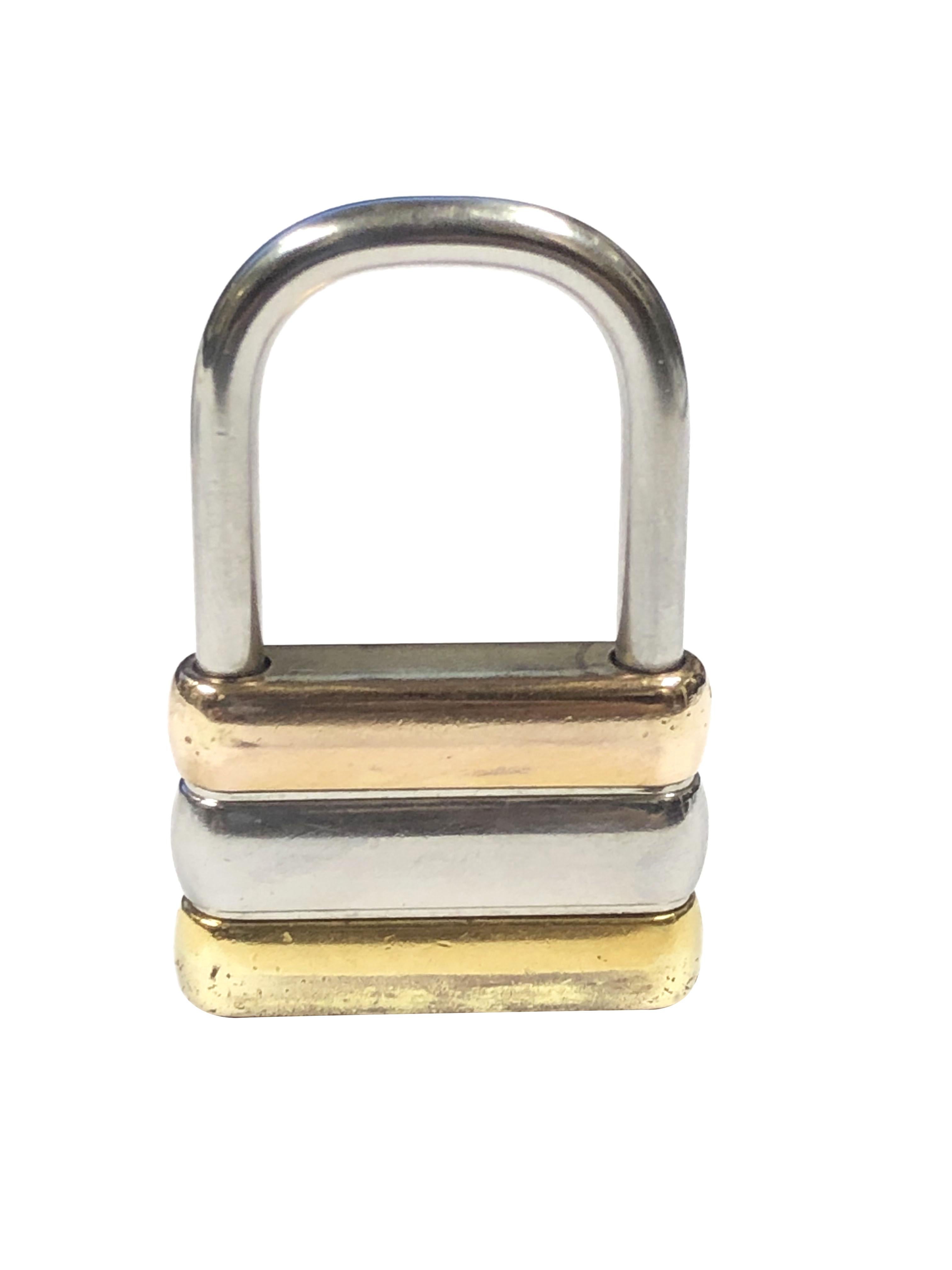 Circa 1980 Cartier Pad Lock Key Ring, measuring 1 7/8 inches in length X 1 1/8 inches, Rose, Yellow and White Gold Plated. Comes in original Cartier felt pouch.
