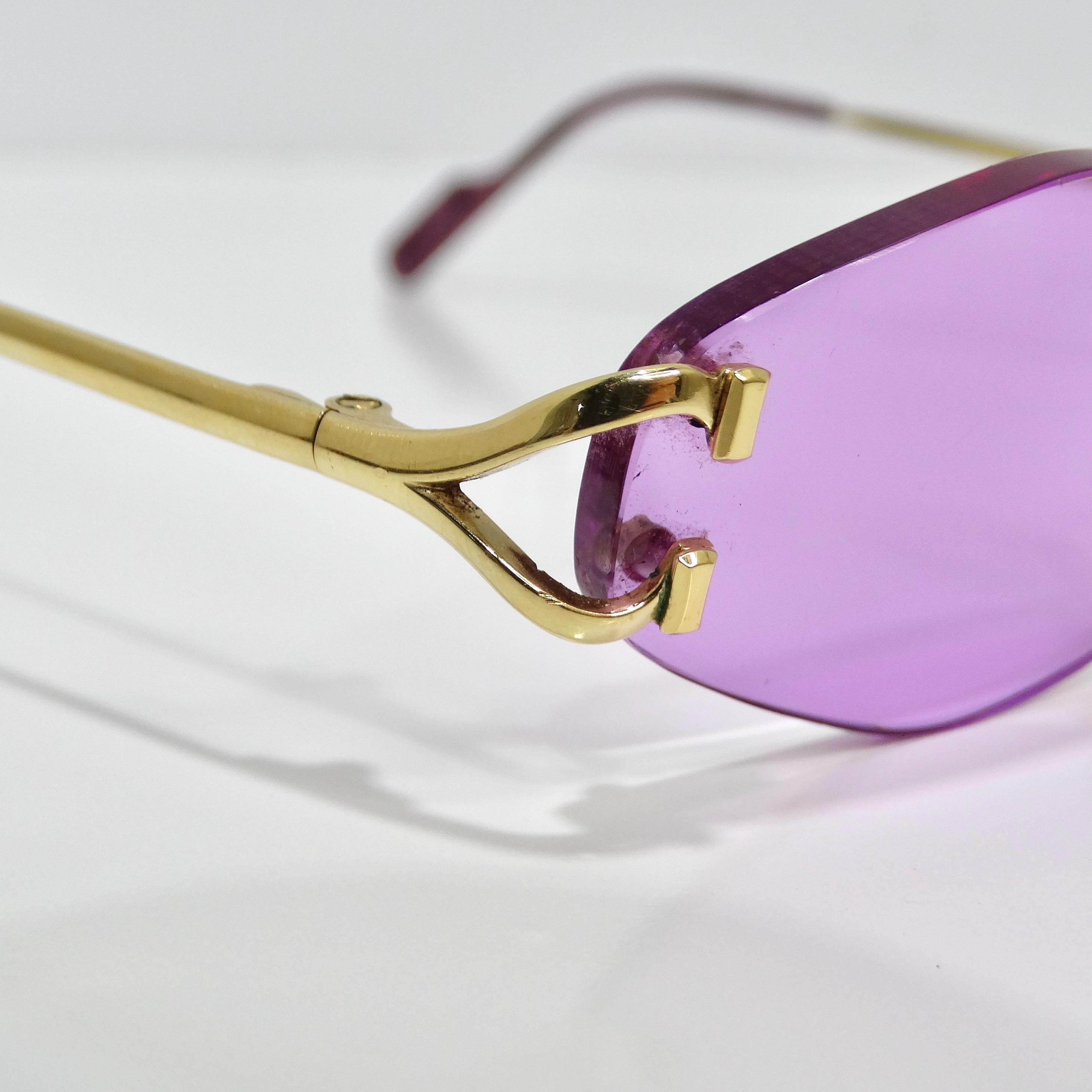 Elevate your style with the Cartier Vintage Rimless Purple Sunglasses, a chic nod to early 2000s fashion. These statement sunglasses boast hexagon rimless lenses in a vibrant purple hue, exuding a bold and sophisticated look. The skinny gold tone