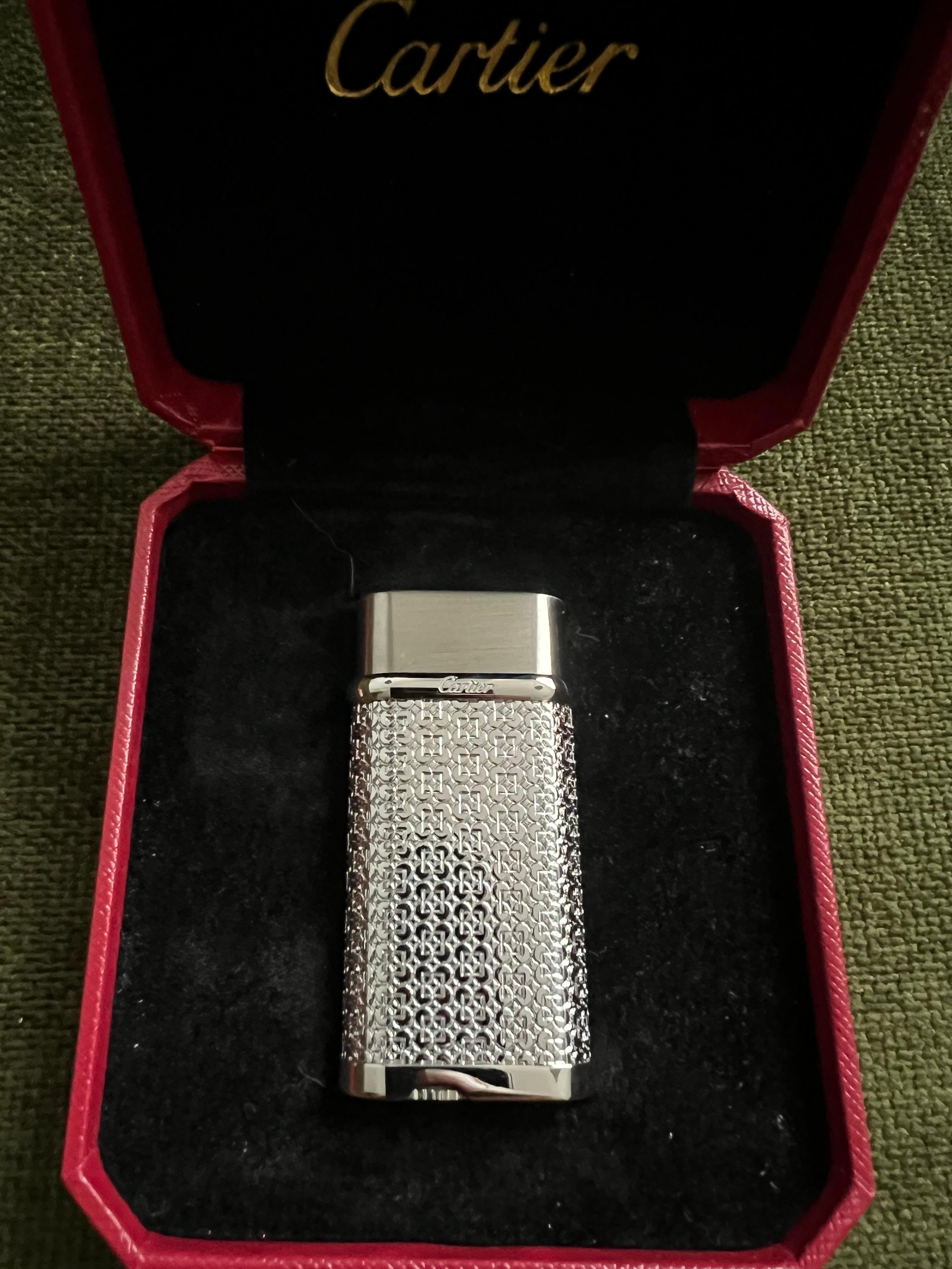 Cartier Vintage Silver Plated “Cartier” Lighter In Original Case Circe 1990

Vintage Silver Plated Cartier lighter with Original Red luxury case, booklet, lints and outside Origial box. 
A back stock item that has never been used 
Serial no: 