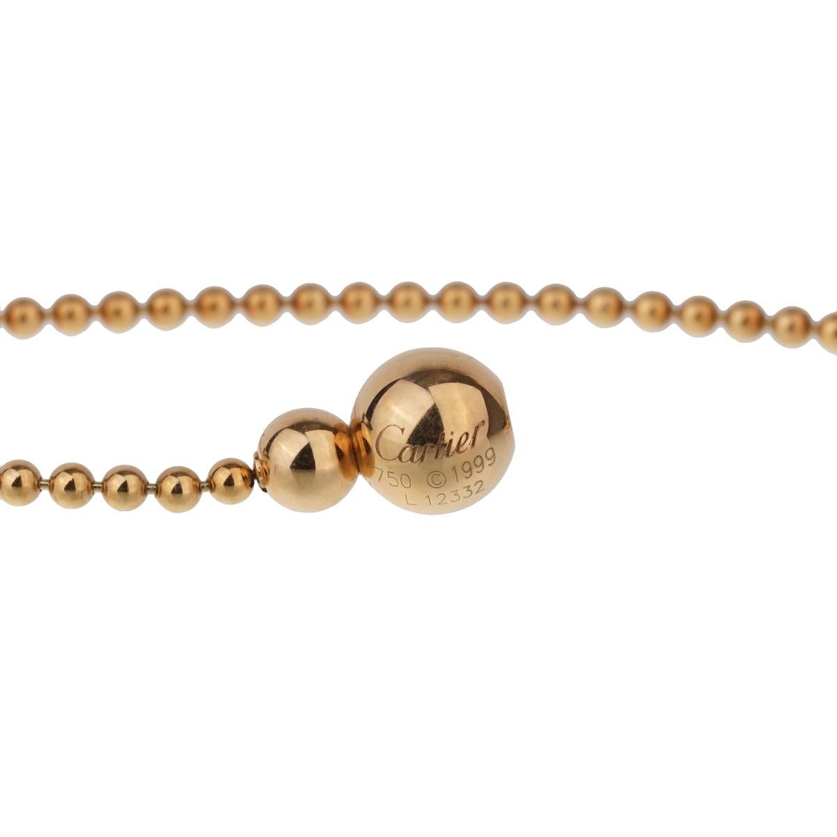A chic Cartier diamond pendant choker circa 1990 featuring a round brilliant cut diamond set in 18k yellow gold. The necklace measures 14.5