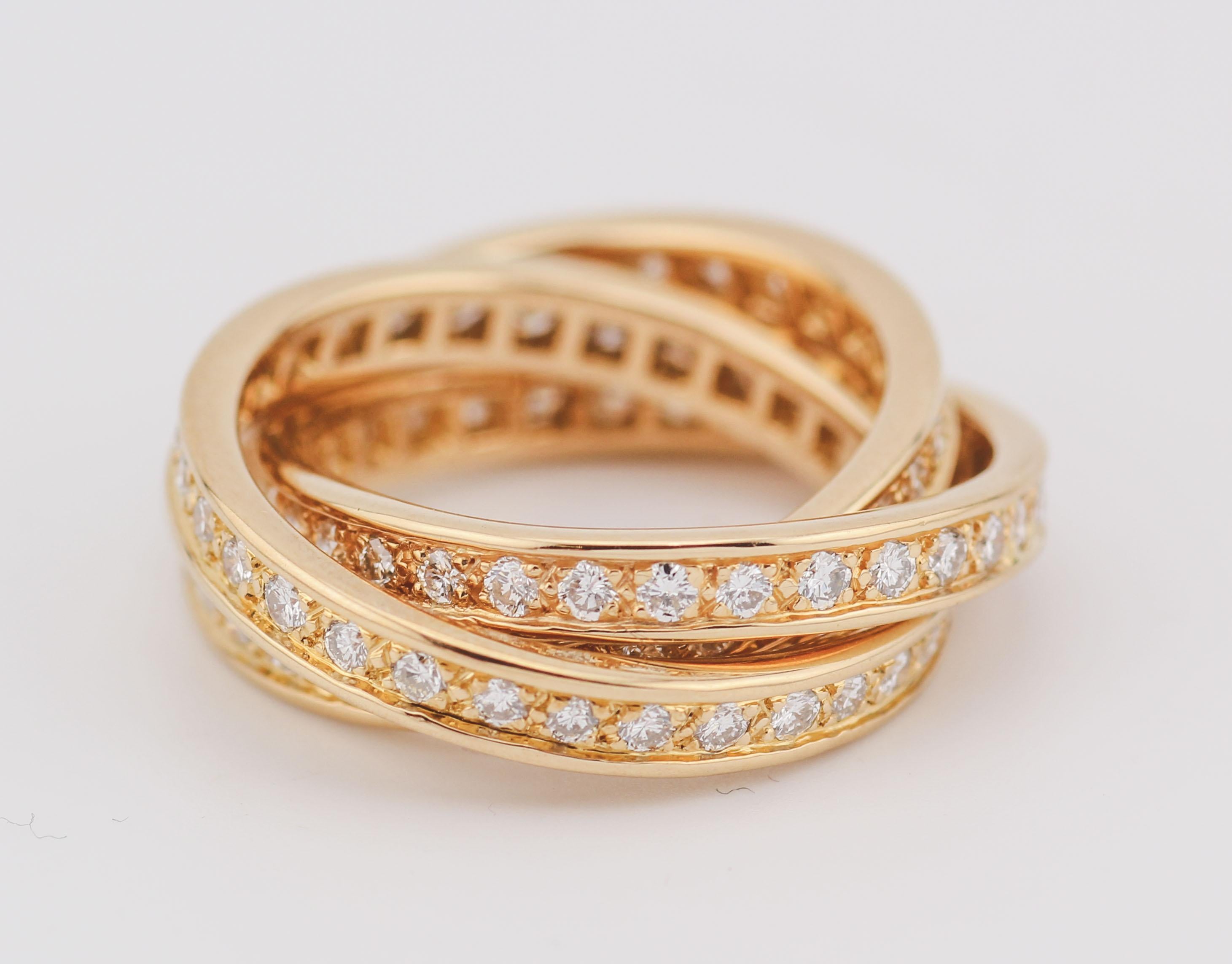 The Cartier Diamond 18k Yellow Gold Trinity Band Ring is a masterful creation, showcasing Cartier's renowned artistry and attention to detail. This exquisite band ring is crafted from luxurious 18k yellow gold, providing a warm and radiant backdrop