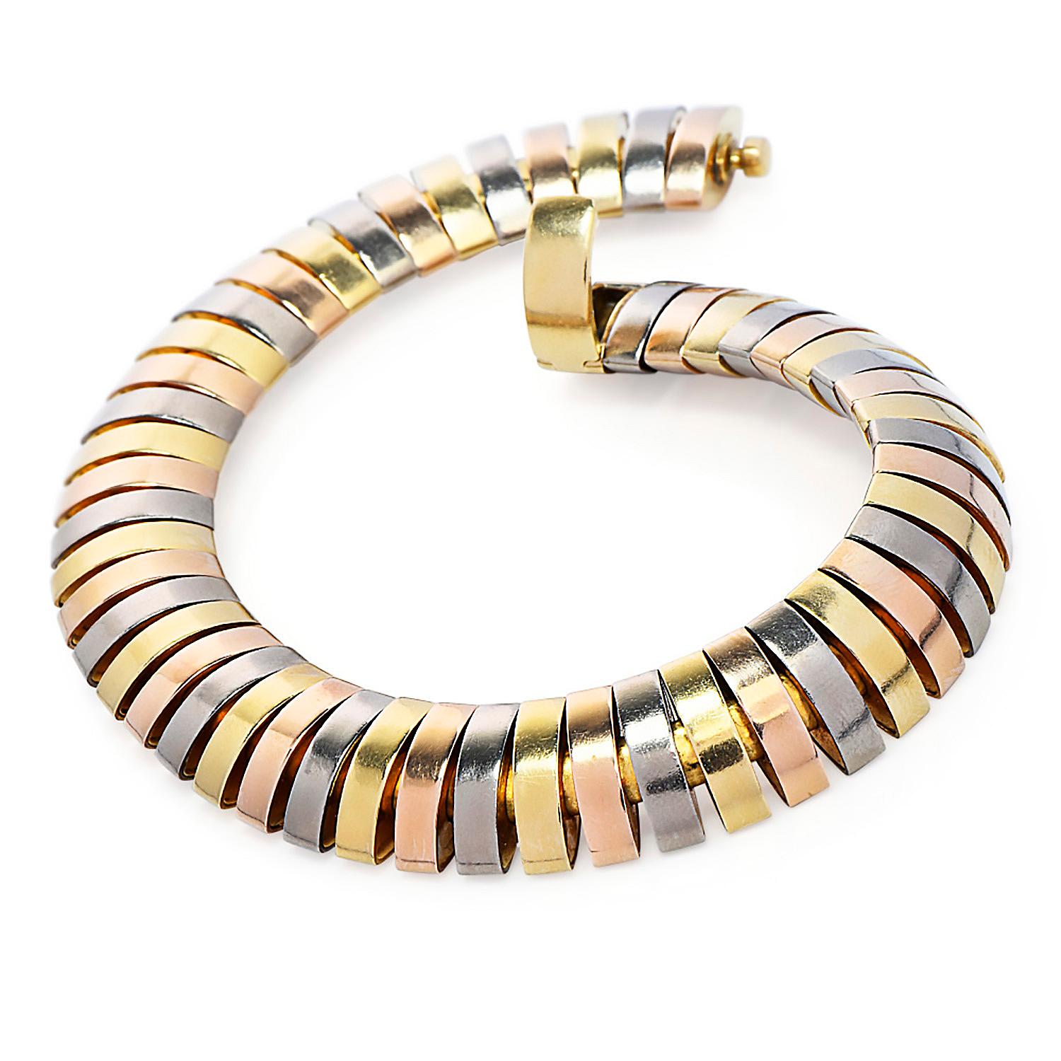 The timeless elegance and beauty from Cartier, 

Is represented on this signature Tri-Color Tubogas Link Bracelet.

Made in solid 18K Gold, with highly polished white, rose & yellow gold omega-shaped wide Links.

Secured by an insert clasp, with a