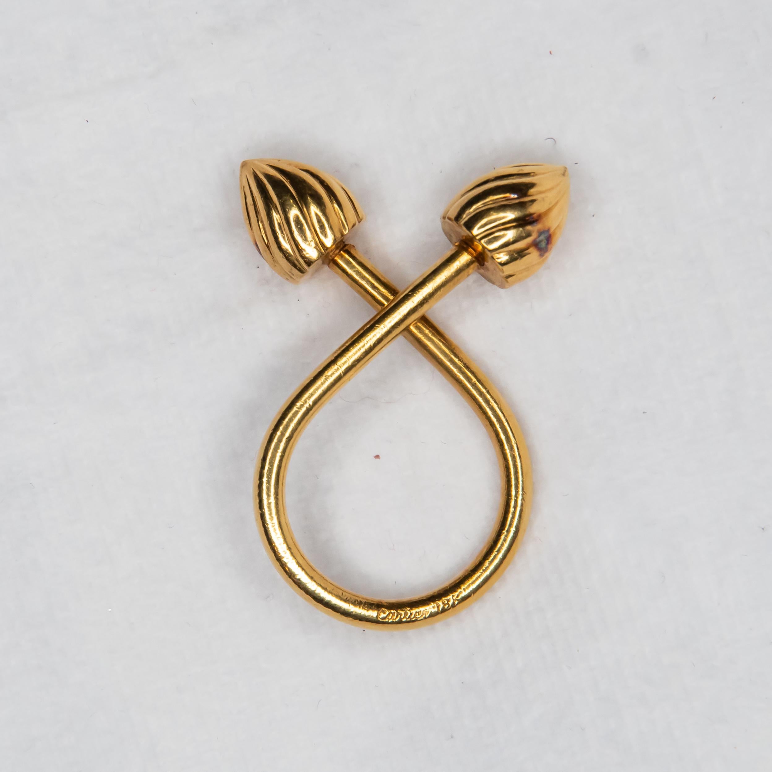 Definitely one of the most recognized names in the world.  Cartier.  We present a vintage unique and very rare fluted top key holder from this famous house.  Crafted in 18 karat yellow gold, the key holder is curved with two fluted tops.  One top