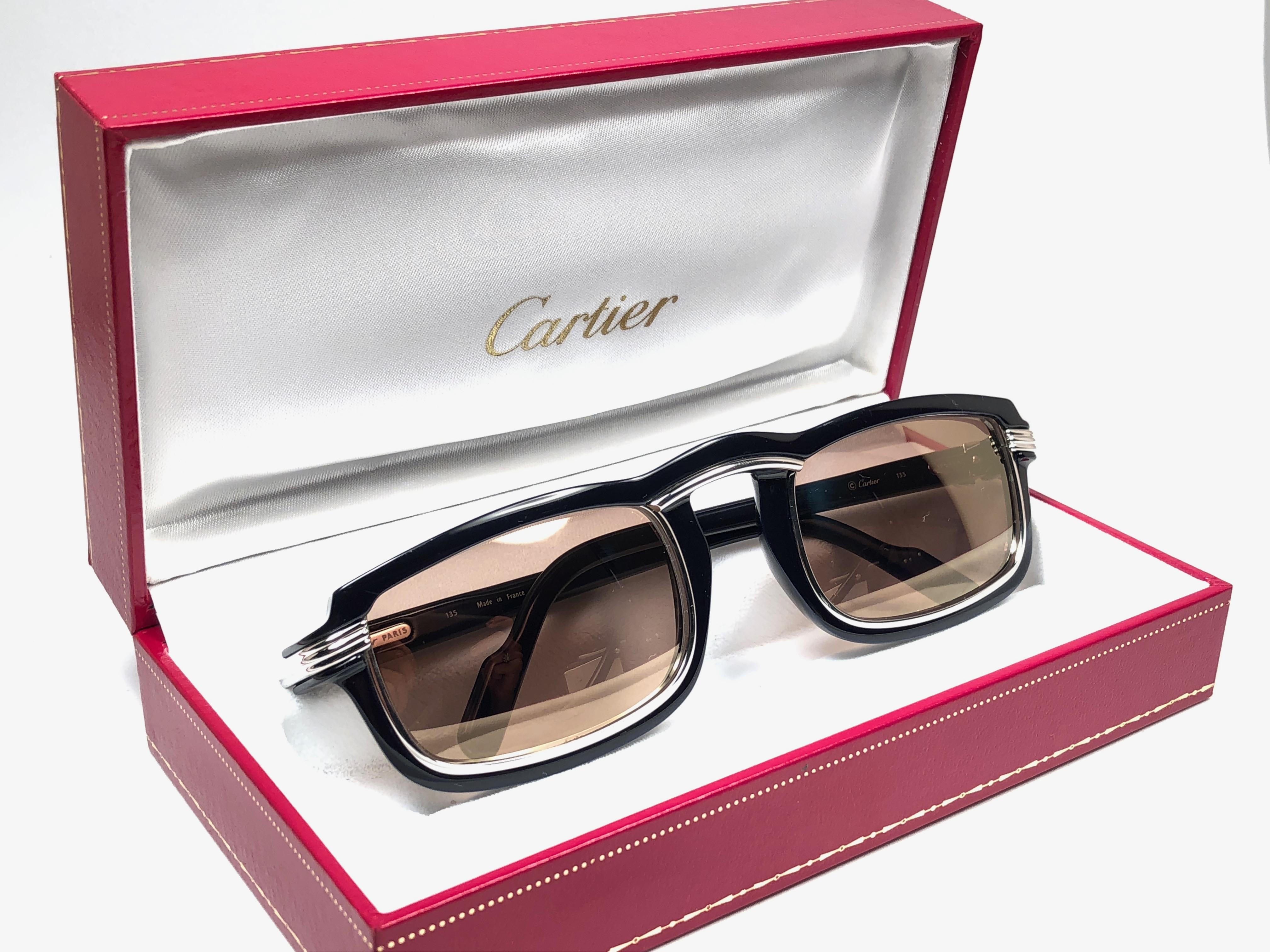 1991 Original Cartier Vertigo Art Deco Sunglasses with spotless amazing brown medium mirrored lenses (uv protection). 
Frame has the famous platinum accents in the middle and on the sides.
All hallmarks. Cartier signs on the earpaddles. Both arms