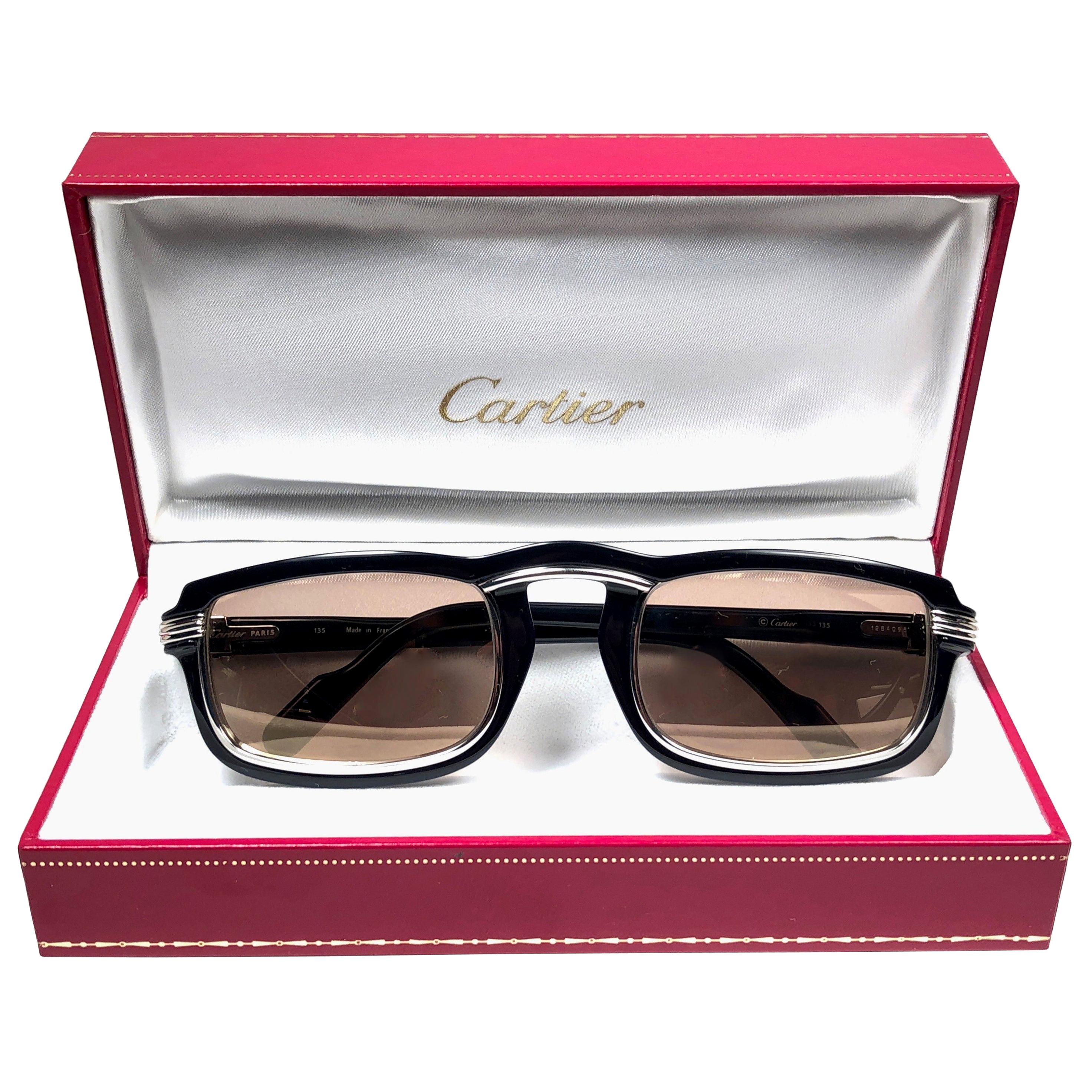 1991 Original Cartier Vertigo Art Deco Sunglasses with spotless amazing brown medium lenses (uv protection). 
Frame has the famous platinum accents in the middle and on the sides.
All hallmarks. Cartier signs on the earpaddles. Both arms sport the C