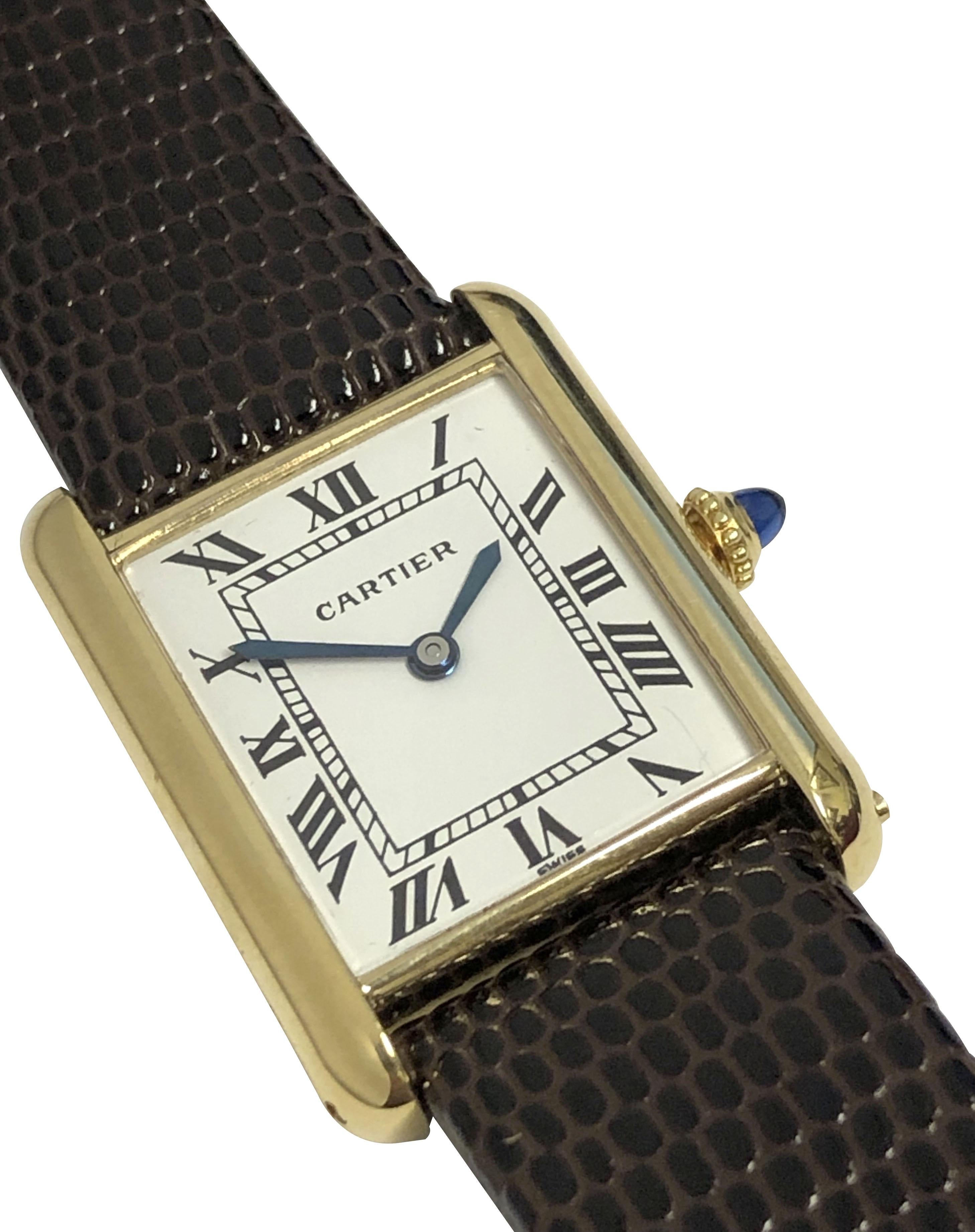 Circa 1970s Cartier Classic Tank Wrist Watch, 23 X 22 M.M 18k Yellow Gold 2 Piece case, 17 Jewel, Mechanical, Manual wind Nickle Lever movement, White Dial with Black Roman Numerals, Sapphire Crown and Glass Crystal. New Brown Lizard Grain Strap