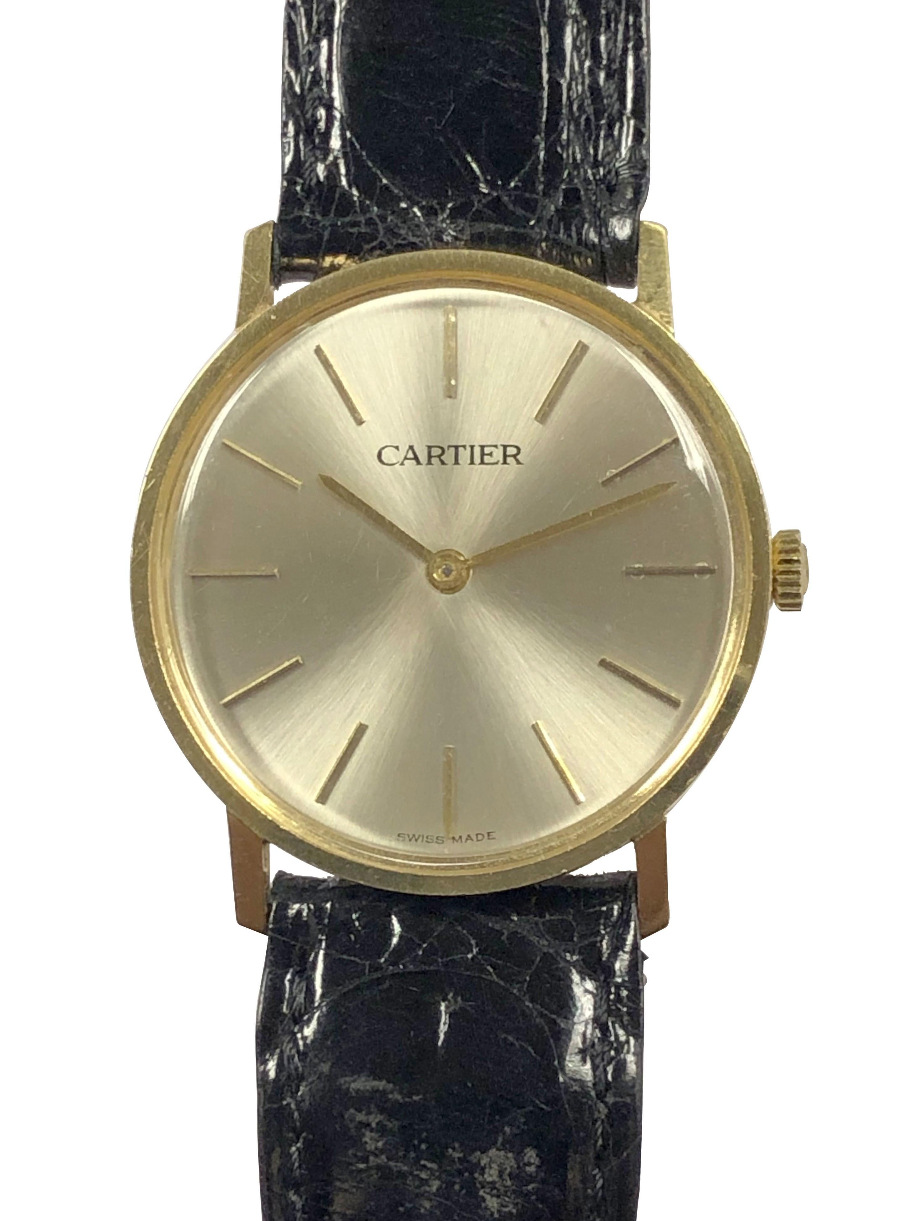 Circa 1960 Cartier Mid Size Wrist Watch, 30 M.M. X 6 M.M thick 18k Yellow Gold 2 piece case, Cartier Inc. 17 jewel mechanical, Manual wind movement. Silver Satin Dial with raised Gold markers. New De Beer Black Crocodile  Strap with a Cartier Gold