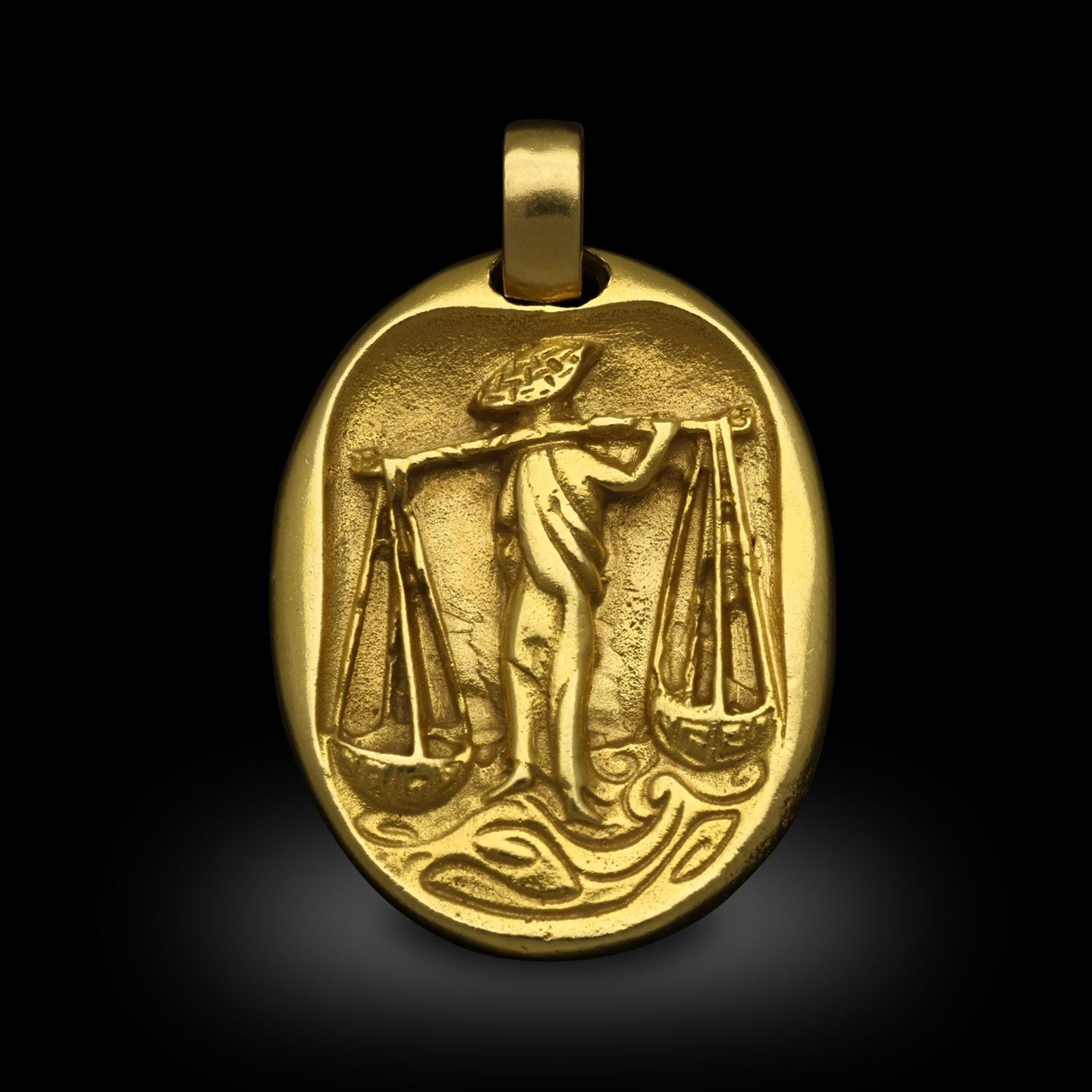 A vintage yellow gold zodiac libra pendant by Cartier, circa 1970. The 18ct yellow gold pendant is engraved on the front with a figure carrying the scales of libra, the reverse has the zodiac symbol for libra, suspended from an oval