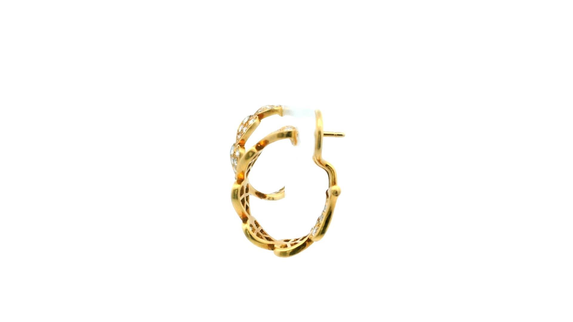 These earrings from the romantic Virgo collection by Cartier feature heart-shaped designs crafted from 18k yellow gold. They are set with round brilliant diamonds, which have an estimated total weight of 1.80 carat. Made in France in the 2000s,