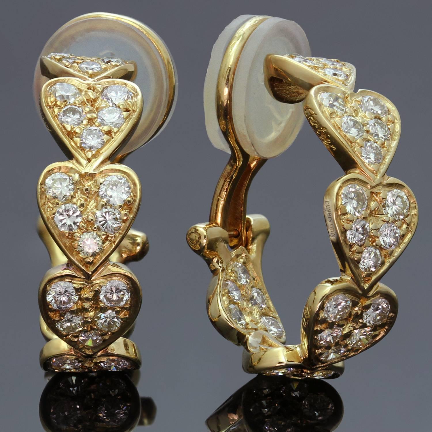These fabulous Cartier earrings from the romantic Virgo collection feature heart-shaped half-hoop clip-on design crafted in 18k yellow gold and set with brilliant-cut round diamonds of an estimated 1.10 carats. Made in France circa 2000s. 