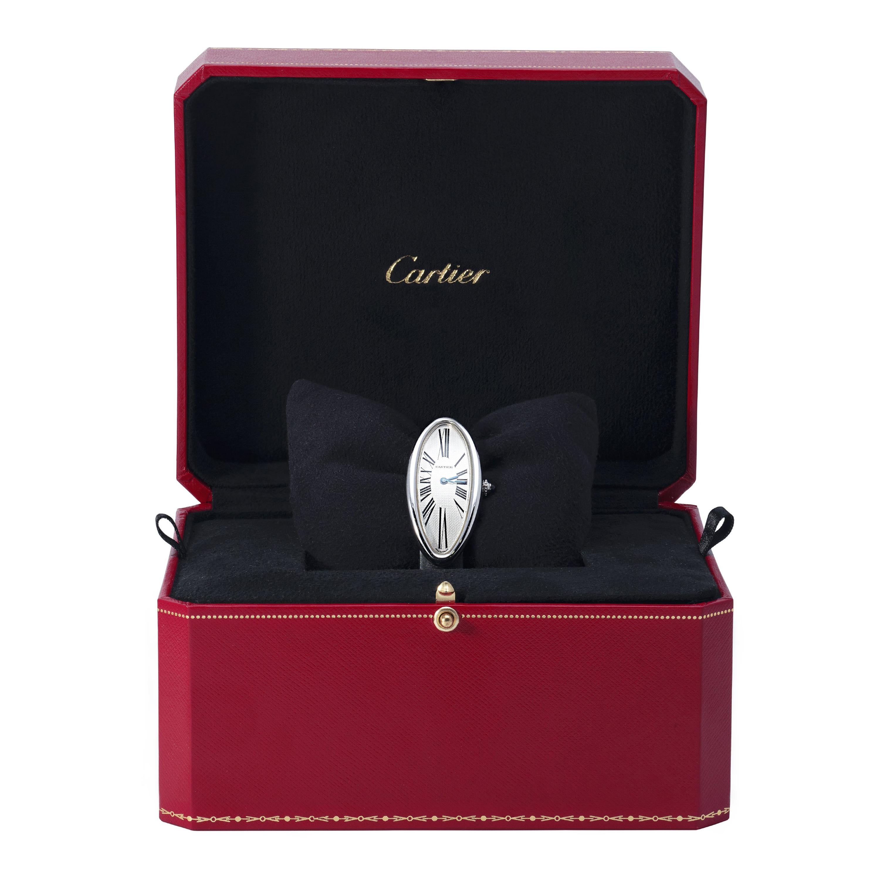Cartier Watch model Baignoire allongée in white gold, Roman numbers, grey leather bracelet. 
N°125188AF Ref 2604. 
Cartier box. 
(40,85 grs)