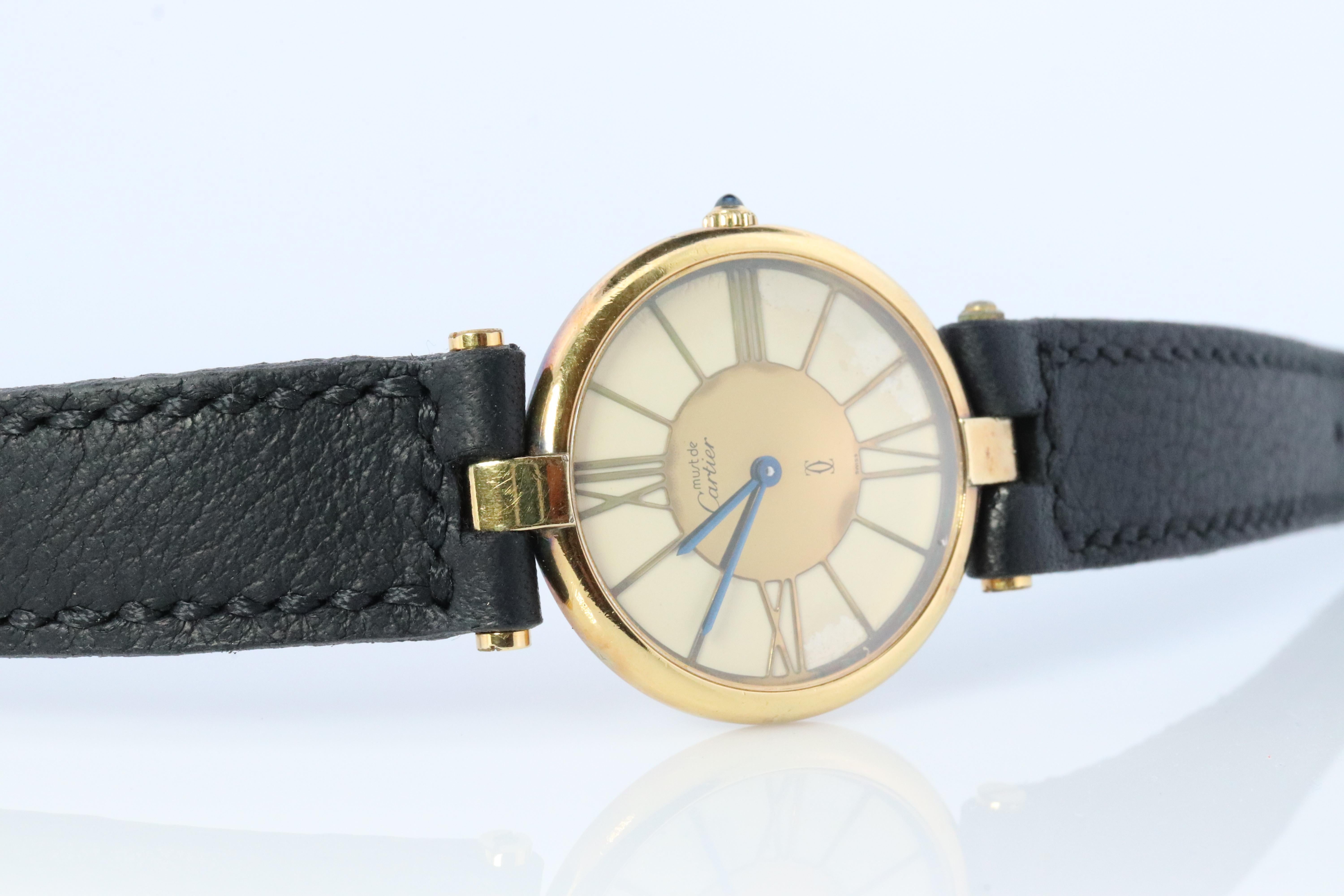 Genuine Cartier watch.

Vintage Must de Cartier 30mm Vendome

Gold and White Roman Dial.

Sapphire Cabochon Crown.

Condition: Comes with Cartier case. Wear consistent with age. New Handcrafted Black Leather Band. Dial has some visible corrosion.