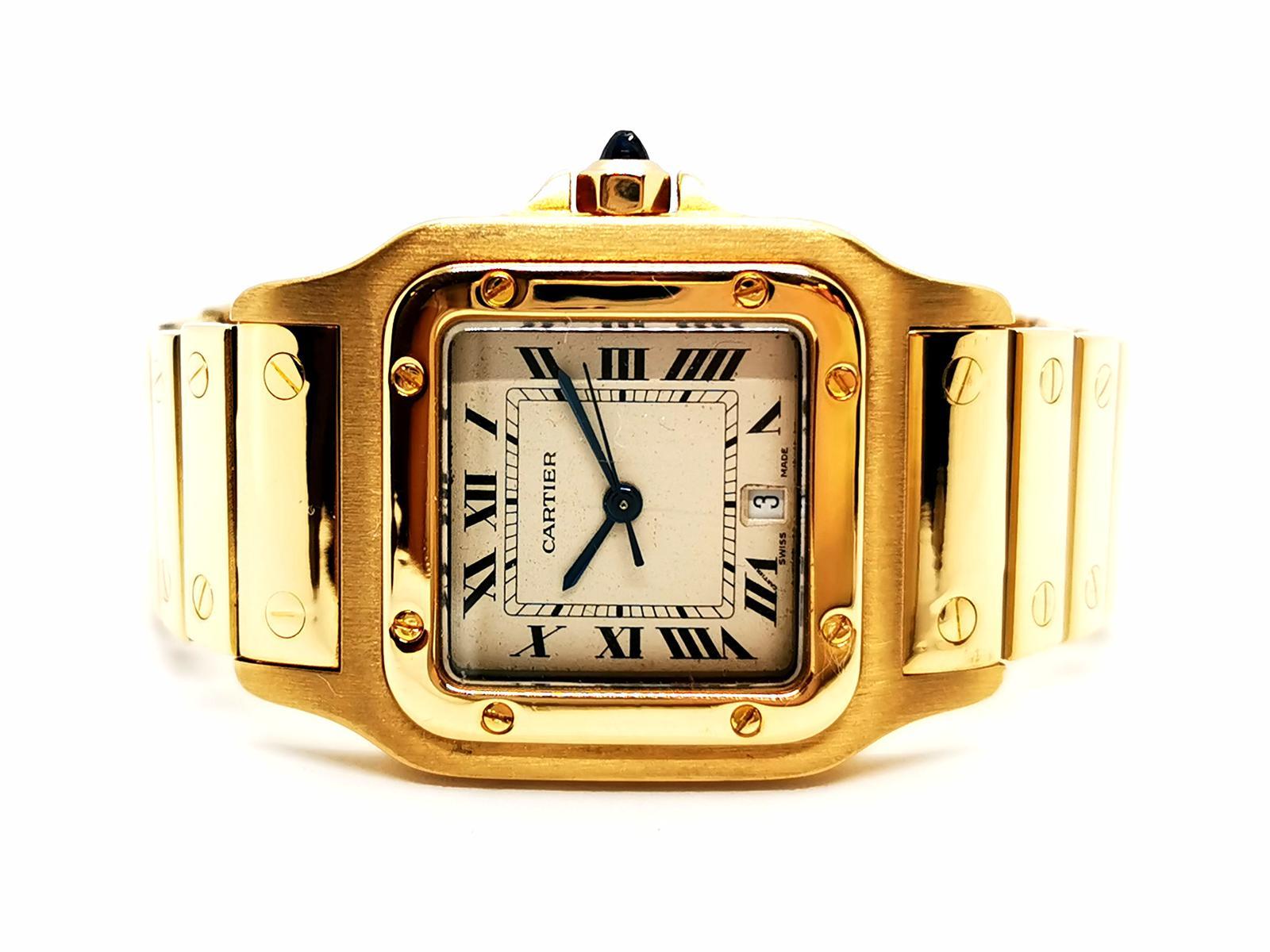 Mixed Watch. signed the house Cartier Collection Santos. 750 thousandths yellow gold (18K). 29 mm case size. index Roman numerals. date at 6 o'clock. crown faceted cabochon sapphire blue about 0.05 ct slightly égrisé. quartz movement . folding