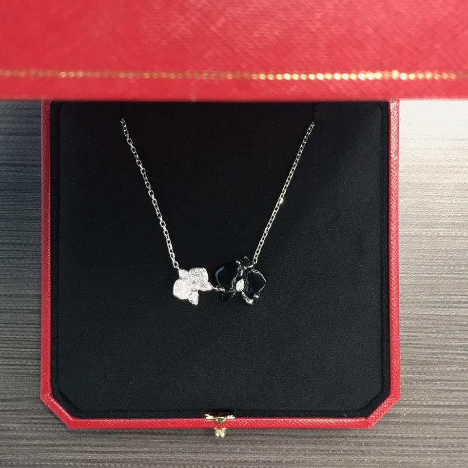 Gently Used
Some wear on the back of the flower motif. Otherwise faces beautifully.
DESCRIPTION
The queen of flowers, the orchid has been meticulously rendered out of 18k white gold and onyx in this Caresse d'Orchidees par Cartier necklace.