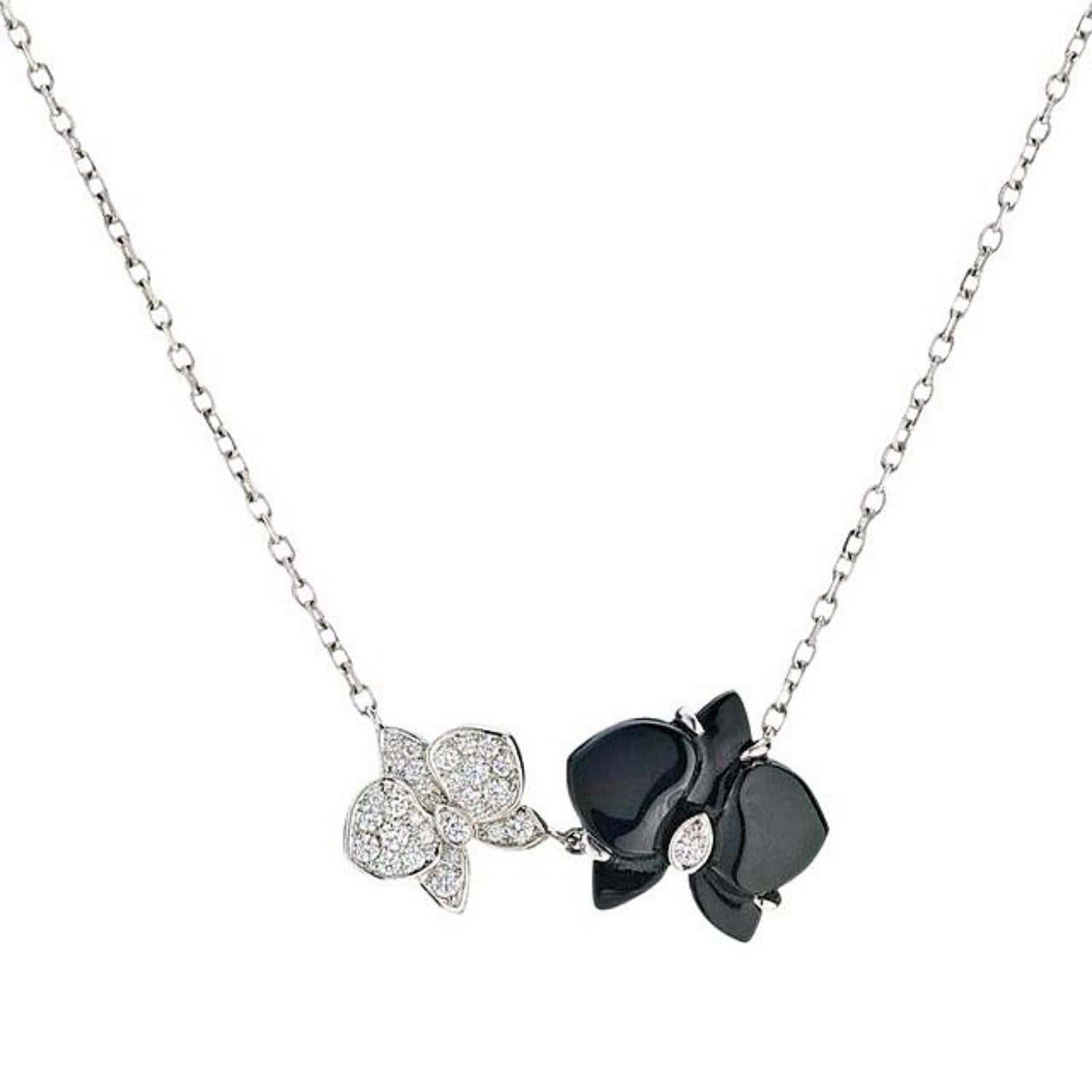 Cartier Caresse d'Orchidees par Cartier Diamond & Onyx Pendant Necklace
Style:  Pendant
Ref. number:  SO2***
Metal:  18kt White Gold
Size / Measurements:  Pendant 1.0 X 0.5 Inches  Chain 16' Inches
TCW:  0.31 tcw
Main Diamond:  28 Round Brilliant