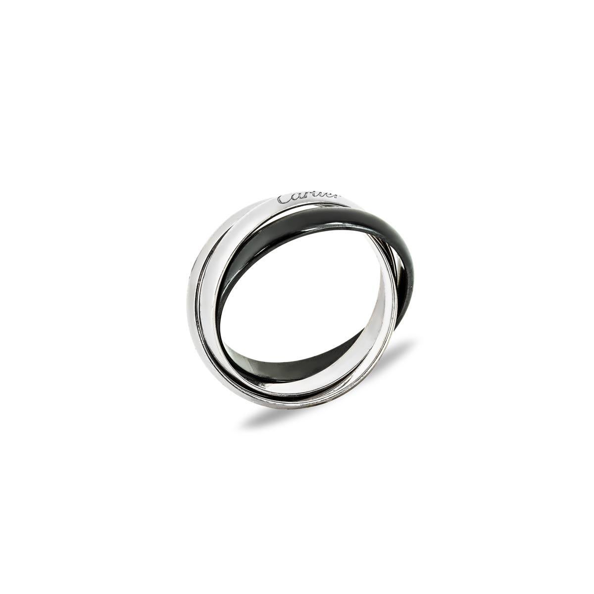 An 18k white gold and ceramic ring from the Trinity de Cartier collection. The ring is made up of three intertwined bands, two in white gold and the other is ceramic, each measuring 3.2mm in width. It is a size 63 and has a gross weight of 8.1