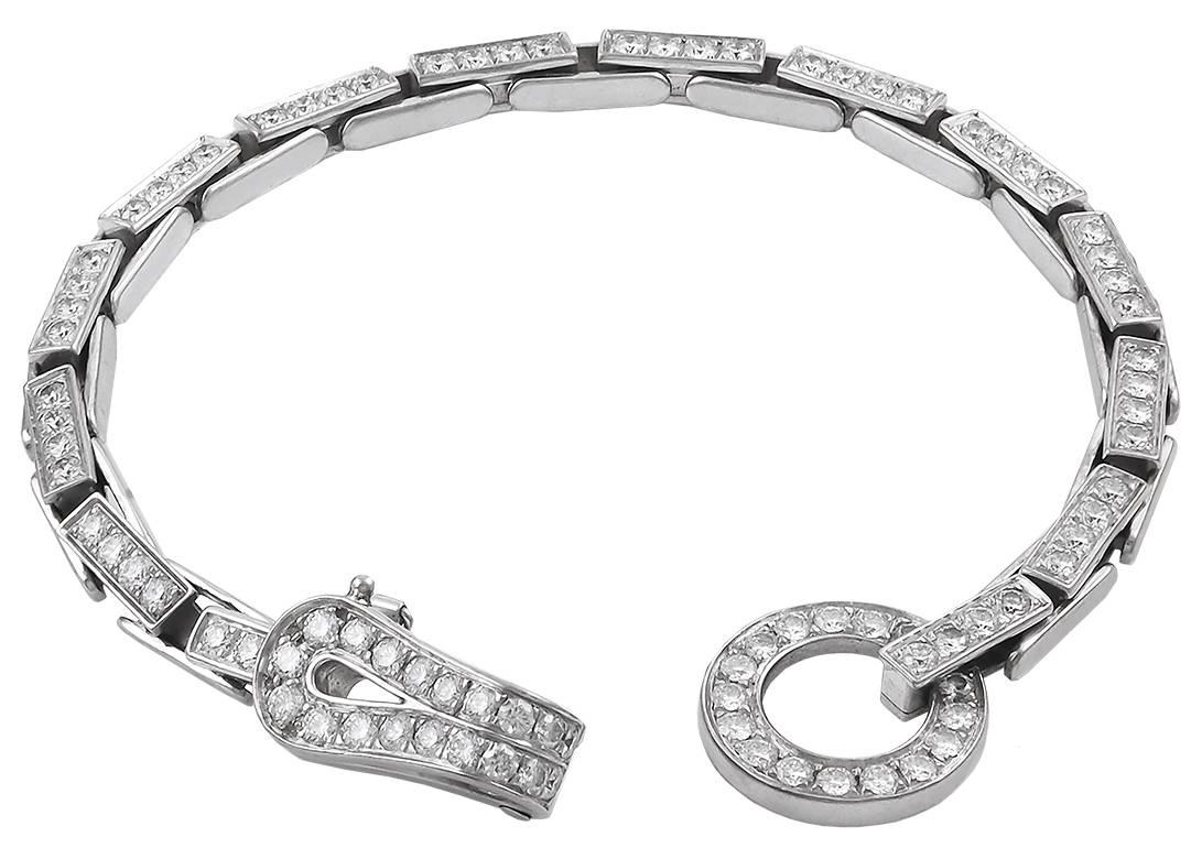 18k white gold diamond ‘Agrafe’ necklace and bracelet, signed Cartier.

This 18k white gold set, comprised of the iconic 'Agrafe' motif which was and inspiration to Cartier from the world of Haute Couture. The jewelry house was inspired by the