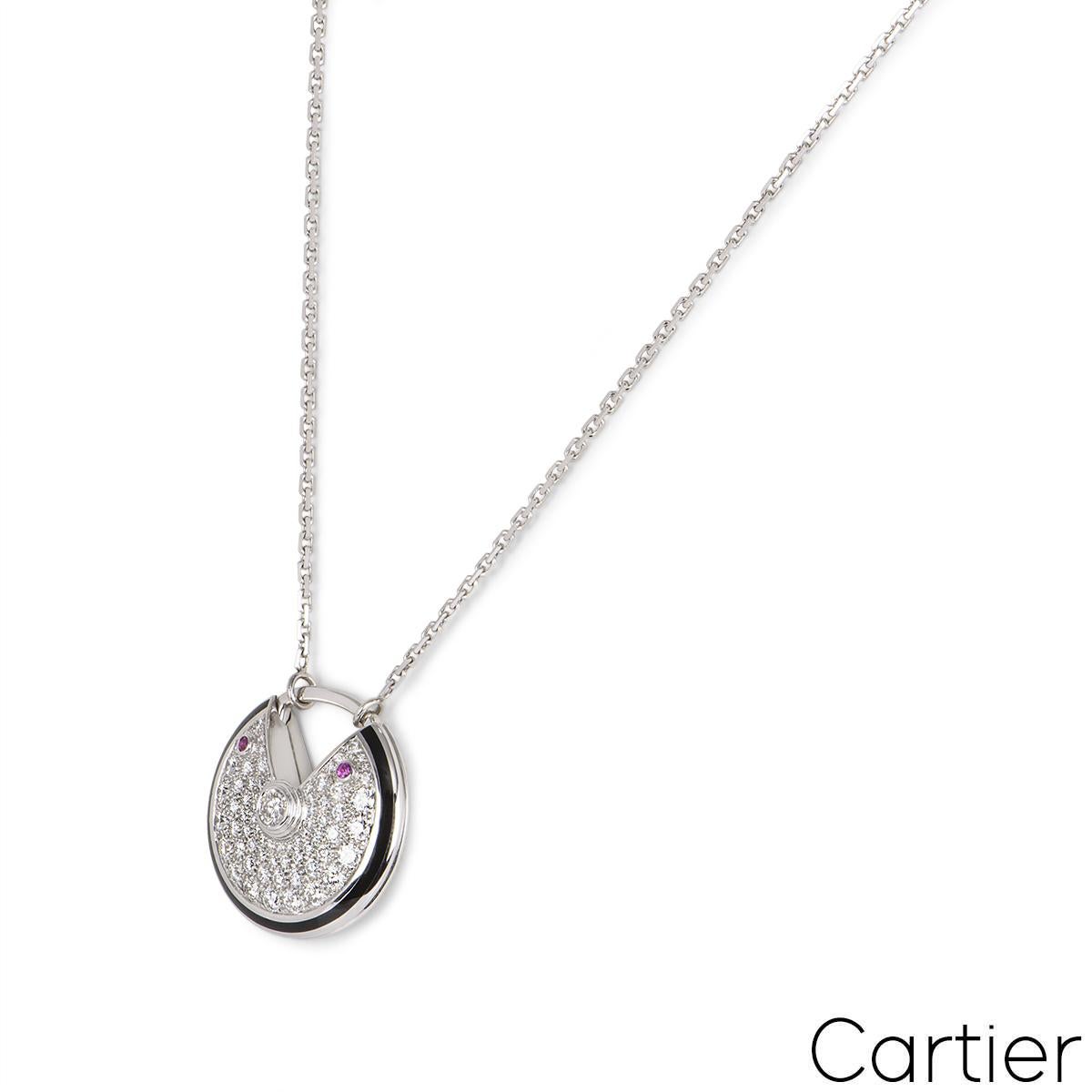 A beautiful 18k white gold diamond necklace by Cartier from the Amulette de Cartier collection. The circular talisman motif has a single round brilliant cut diamond set to the centre in a rubover setting weighing 0.15ct, surrounded by a further 70