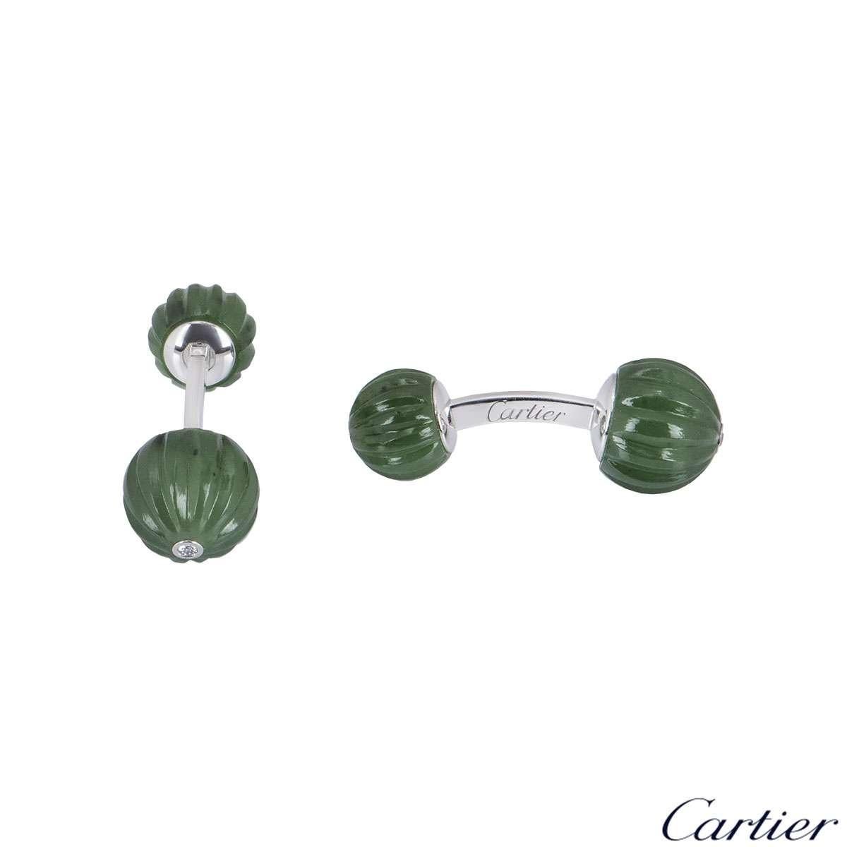 An alluring 18k white gold pair of cufflinks by Cartier. The cufflinks feature 4 jade beads in alternate sizes with a single diamond at the tip of the largest bead. The cufflinks are encased together by a bar fitting with a length of 3.00cm with a