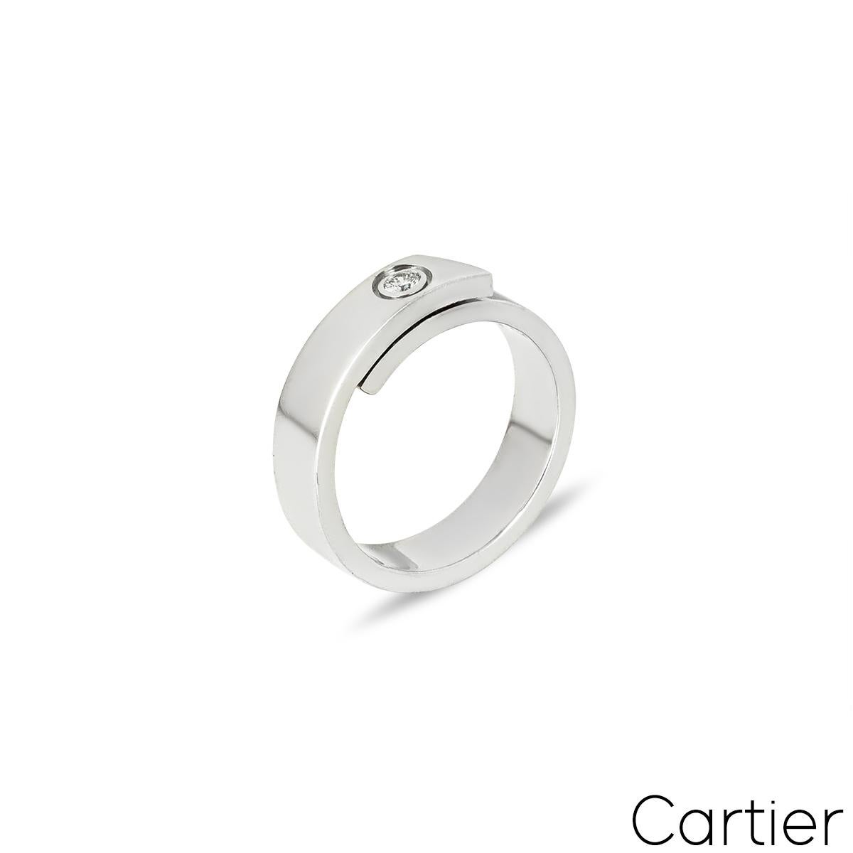 A lovely 18k white gold Cartier diamond ring from the Anniversary collection. The ring comprises of a 5.5mm band overlapping at the centre with a single round brilliant cut diamond, approximately 0.09ct in a rubover setting. The ring is a size UK S