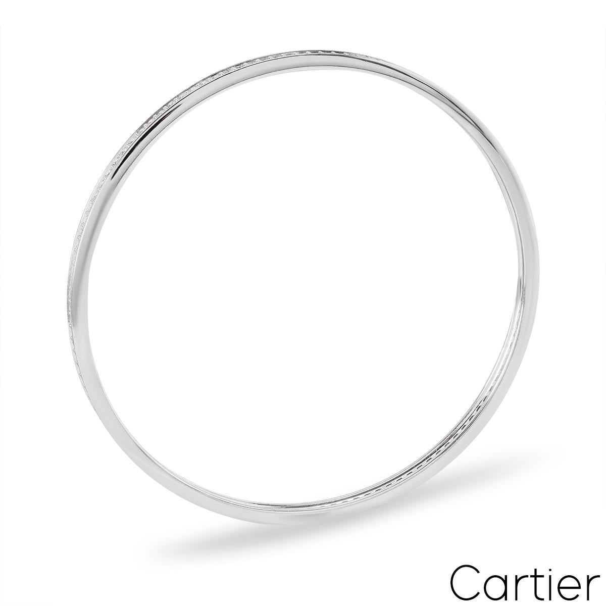 A stunning 18k white gold Cartier diamond bangle. The bangle comprises of a full pave set with 116 round brilliant cut diamonds with a total weight of approximately 2.90ct, F colour and VS clarity. The bangle fits a wrist up to 20.25cm and has a