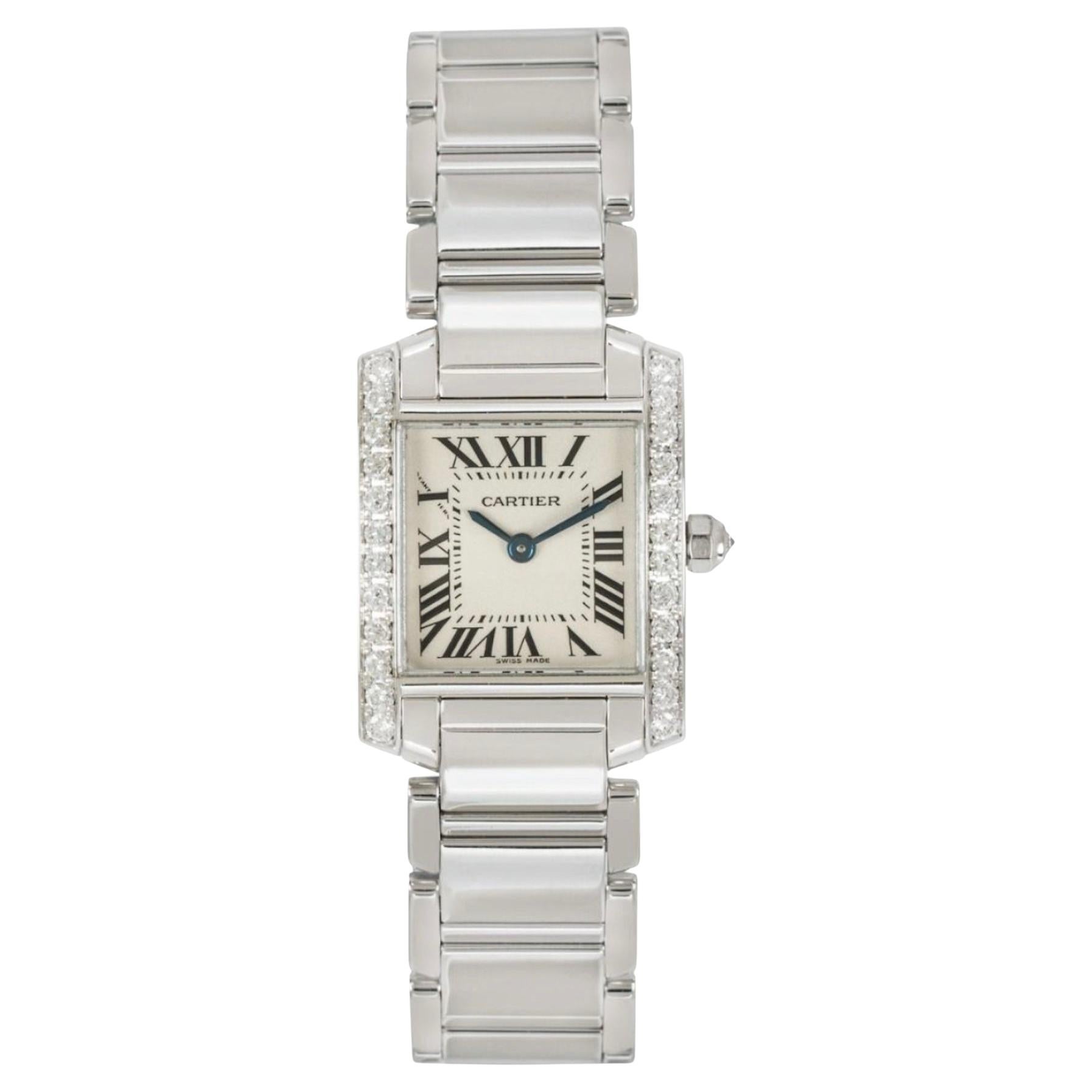 A ladies 20mm Cartier tank Francaise in white gold. Featuring a silver dial with roman numerals, blued-steel sword-shaped hands, a secret Cartier signature at 'X' and a white gold bezel set with 24 round brilliant cut diamonds as well as a crown set